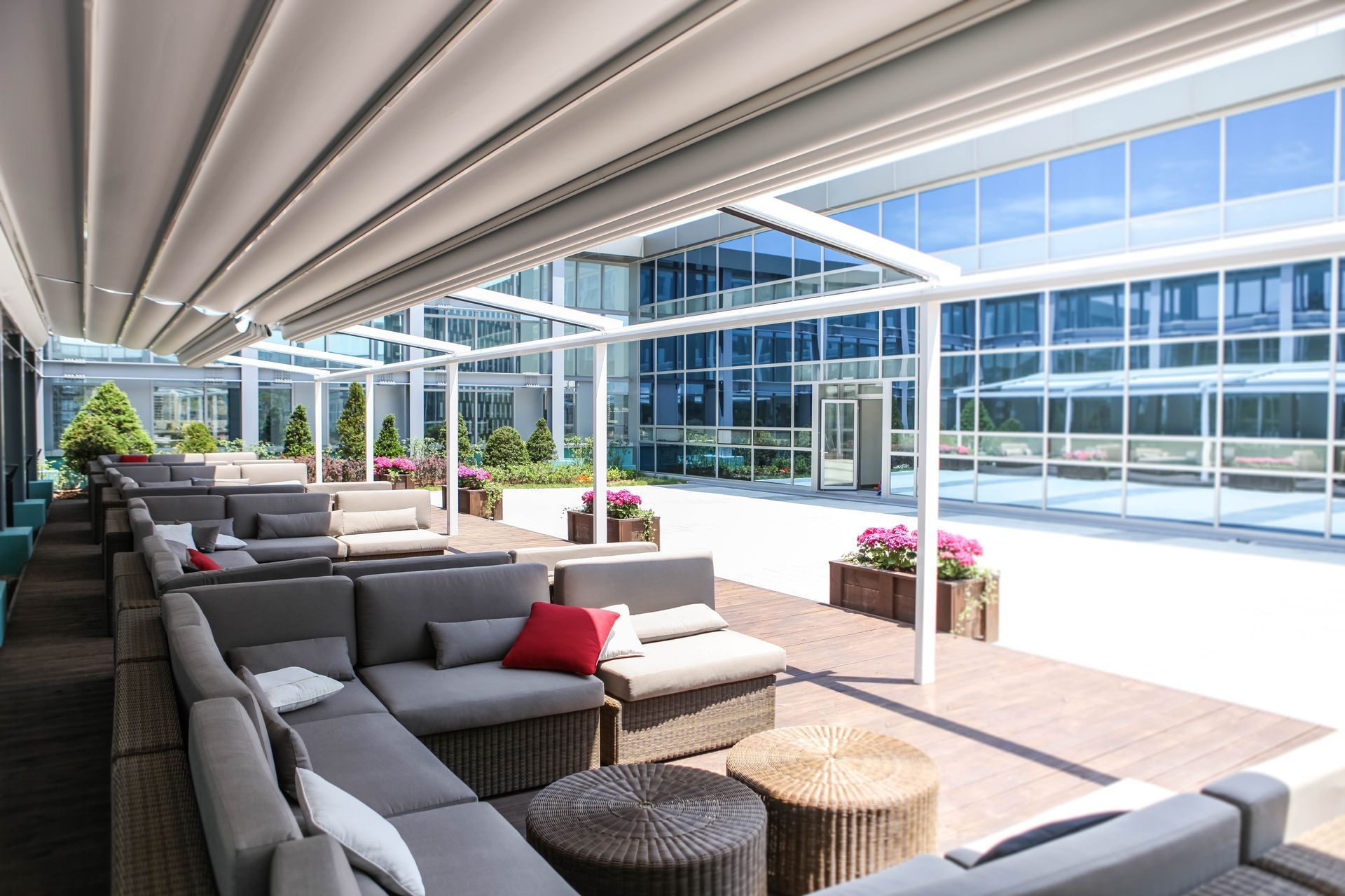 A large patio with a lot of furniture and a pergola - Freehold, NJ - Awning Design Inc