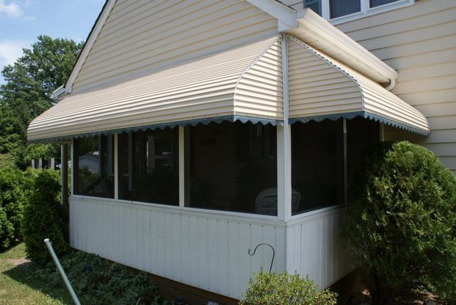 A screened in porch on the side of a house - Freehold, NJ - Awning Design Inc