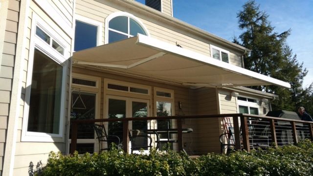 A house with a white awning on the side of it - Freehold, NJ - Awning Design Inc