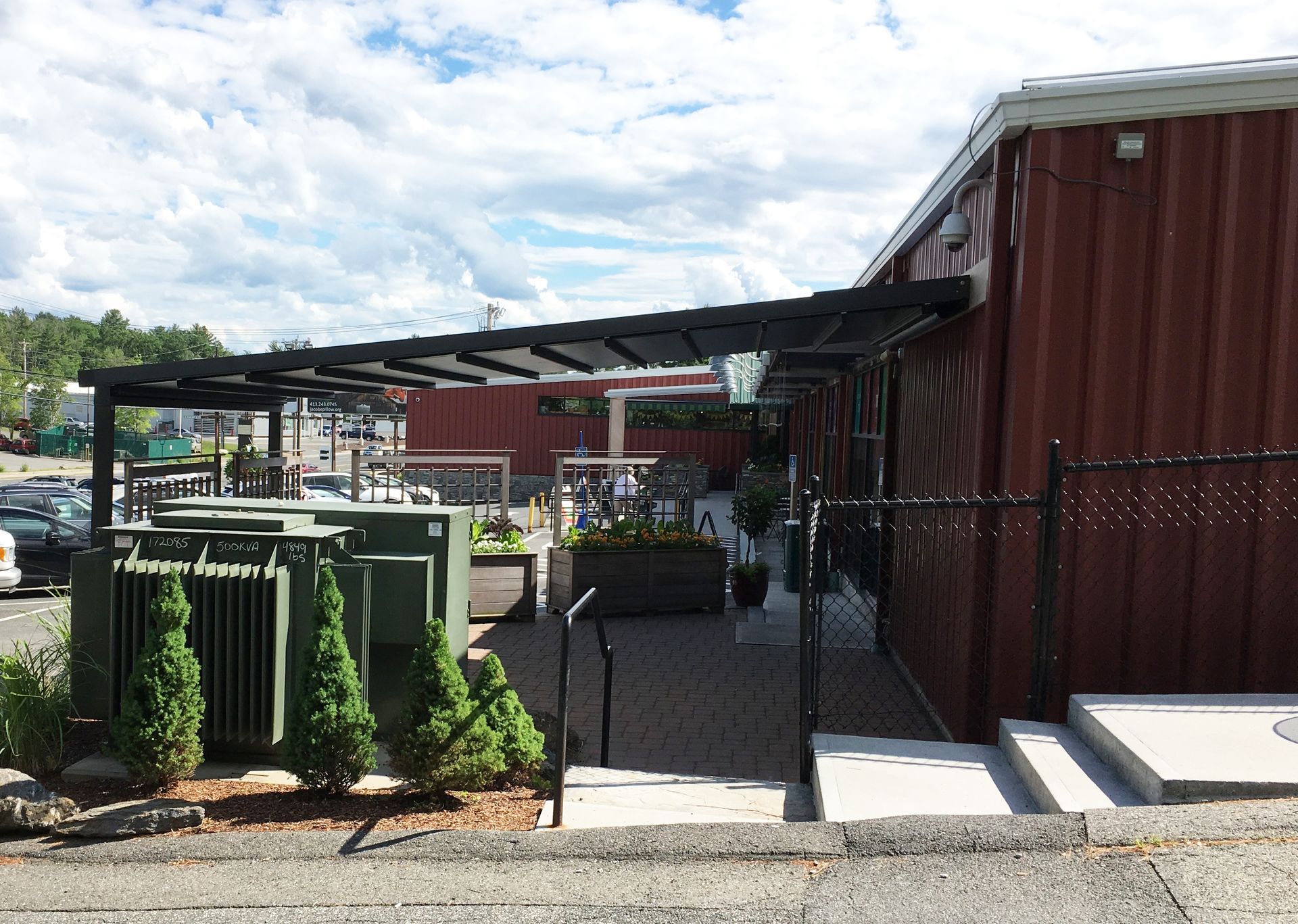 A red building with stairs leading up to it - Freehold, NJ - Awning Design Inc