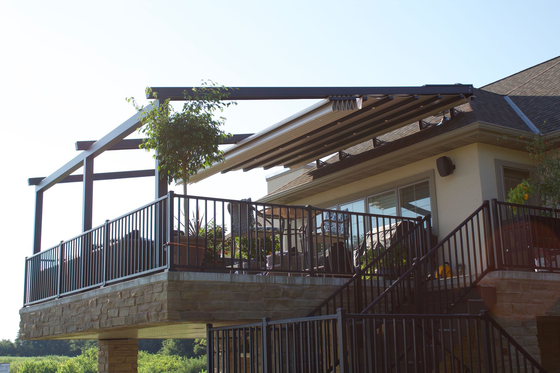 A house with a balcony and stairs leading up to it - Freehold, NJ - Awning Design Inc