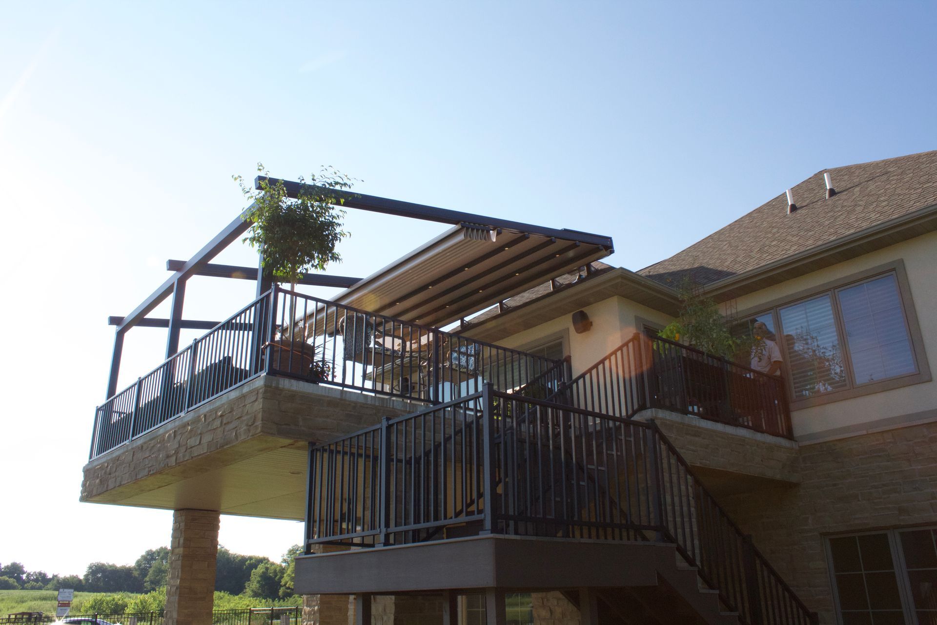 A house with a balcony and stairs leading up to it - Freehold, NJ - Awning Design Inc
