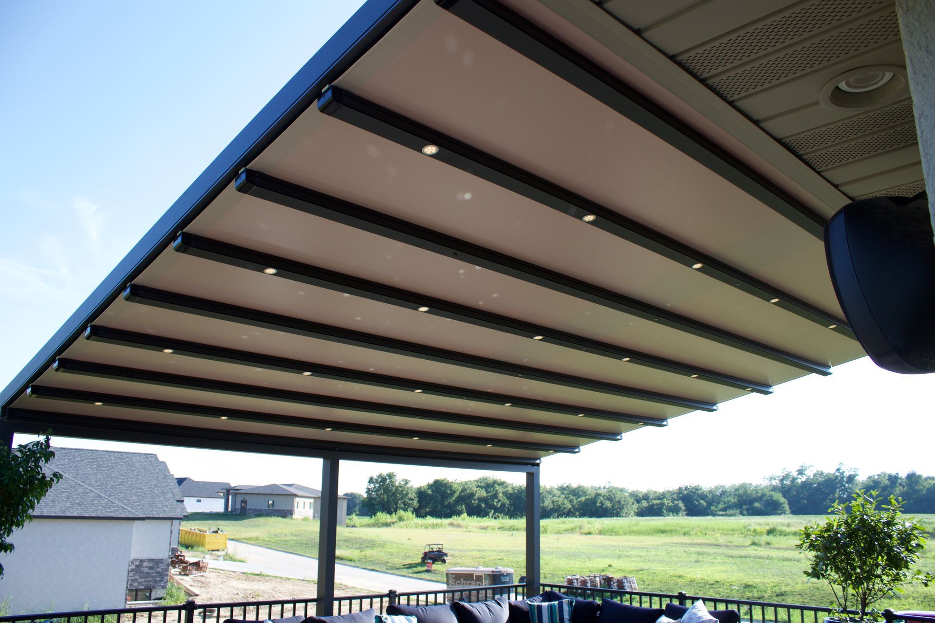 A patio with a canopy over it and a view of a field - Freehold, NJ - Awning Design Inc