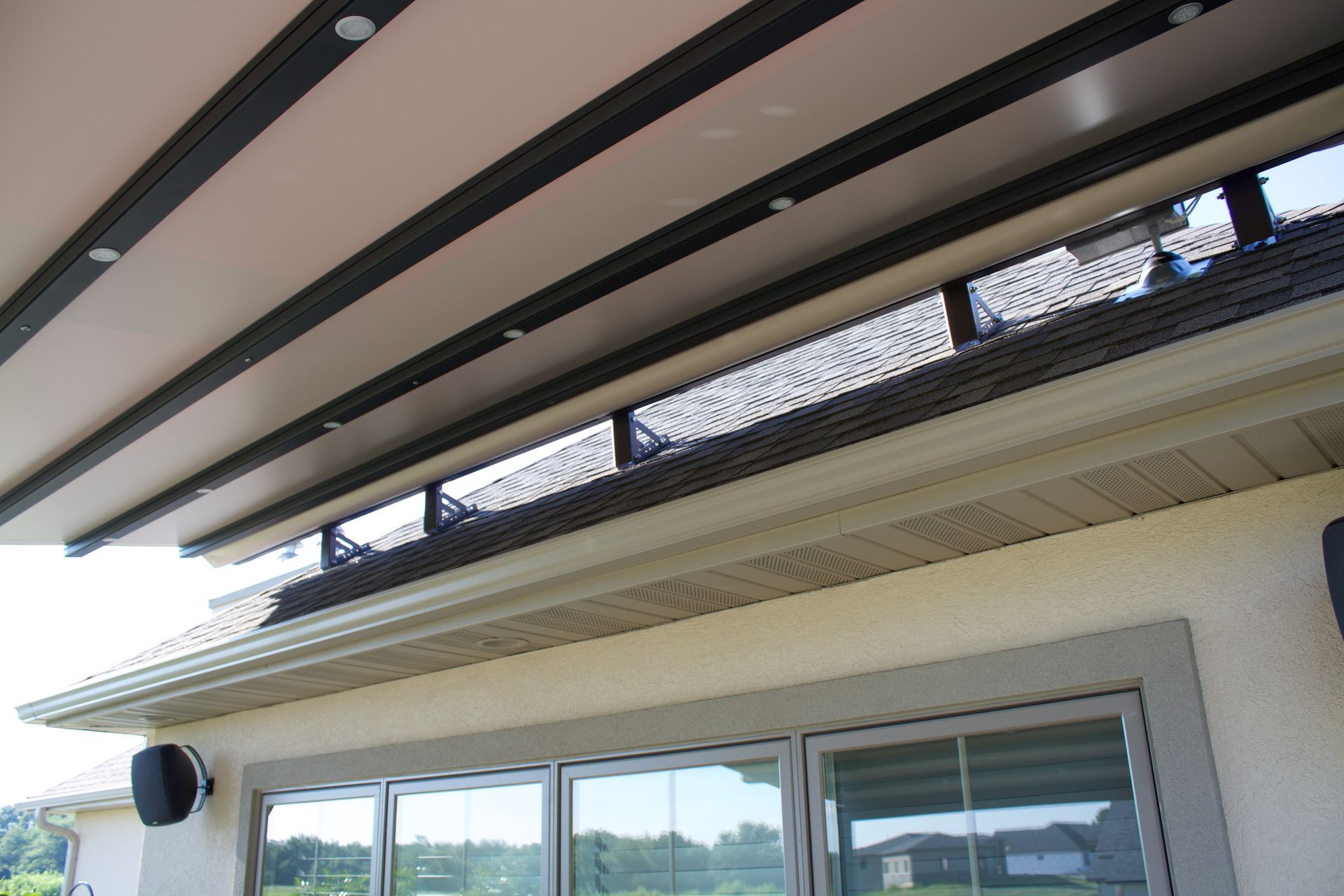 The roof of a house with a canopy over it and a lot of windows- Freehold, NJ - Awning Design Inc