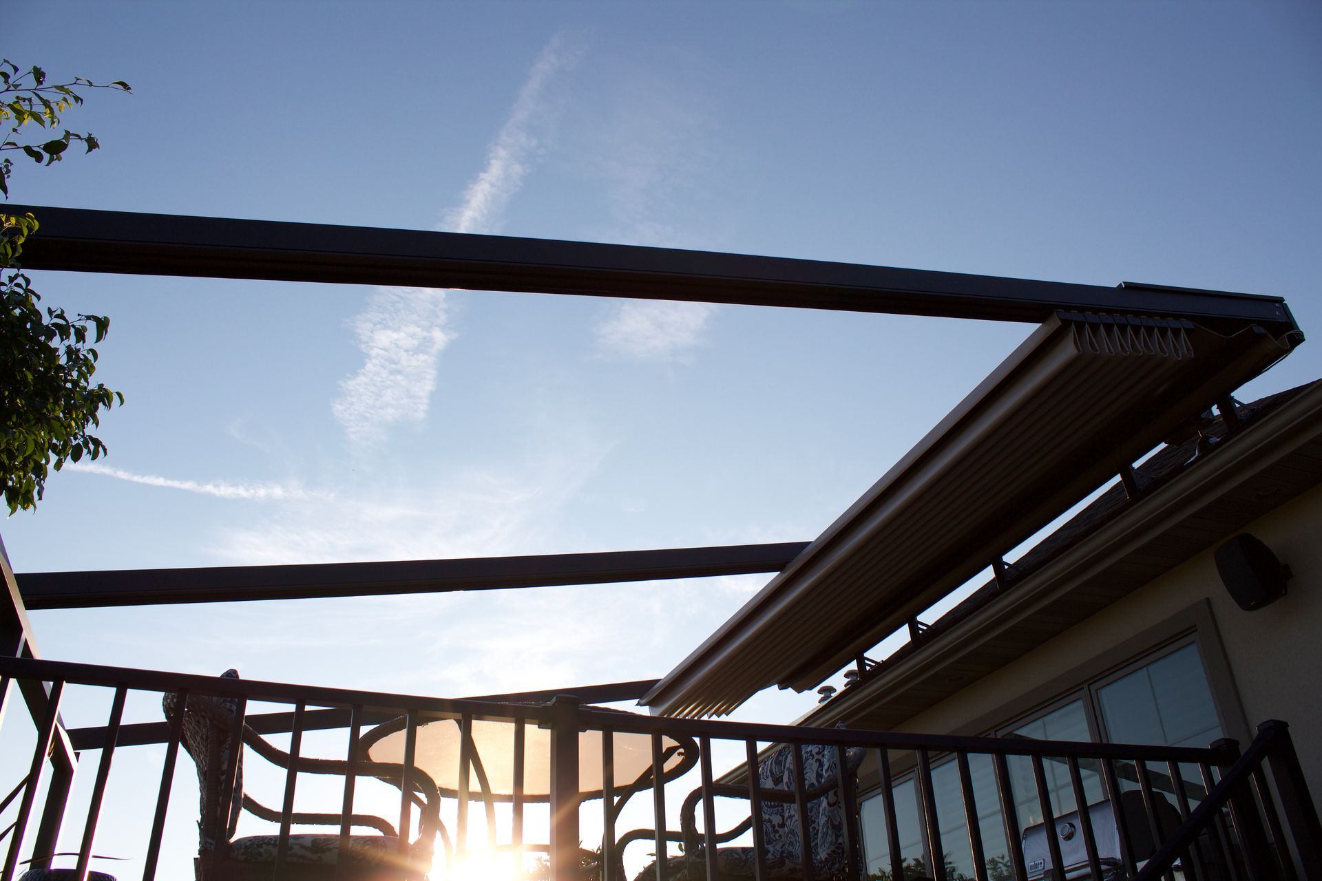 The sun is shining through the fence of a house - Freehold, NJ - Awning Design Inc