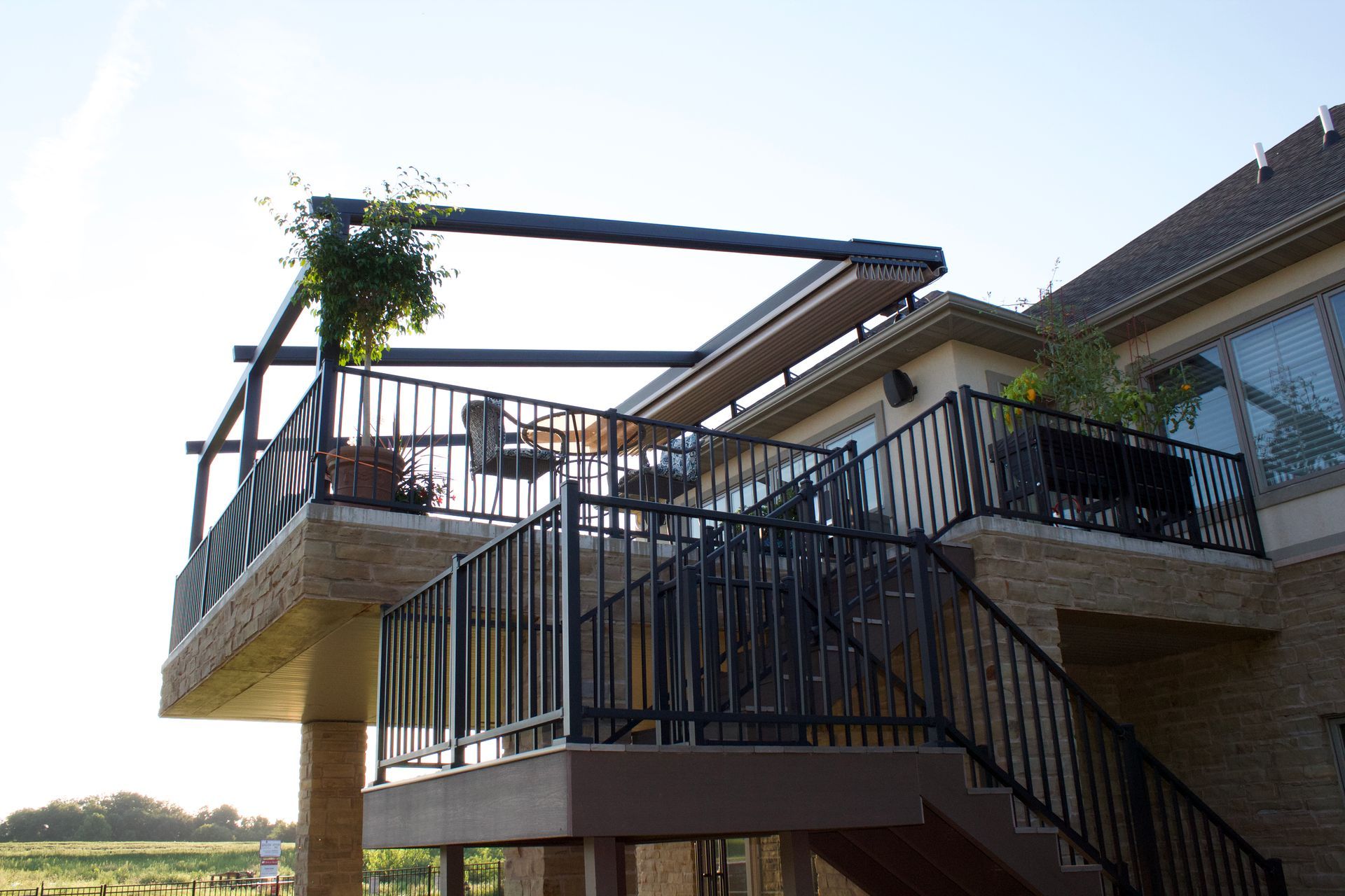 A house with a balcony and stairs leading up to it - Freehold, NJ - Awning Design Inc