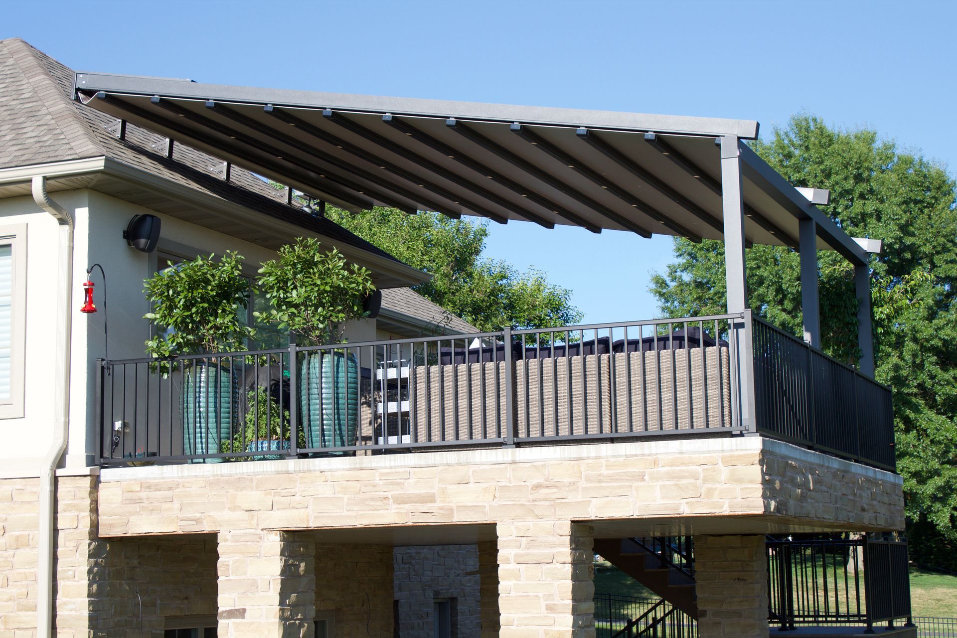 A house with a large deck with a canopy over it - Freehold, NJ - Awning Design Inc