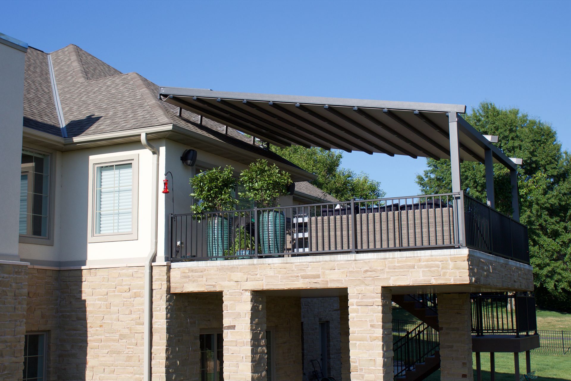 A house with a balcony with a canopy over it - Freehold, NJ - Awning Design Inc