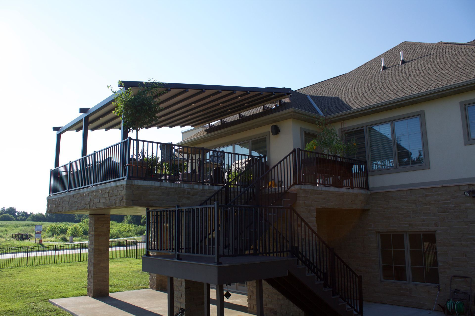 A large house with a large deck and stairs - Freehold, NJ - Awning Design Inc