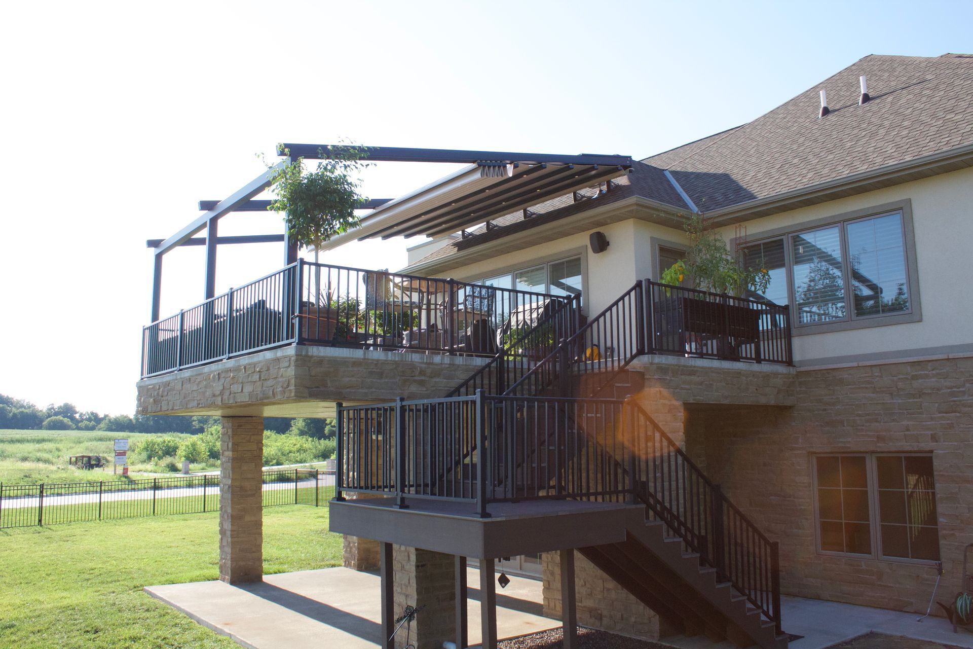 A large house with a large deck and stairs - Freehold, NJ - Awning Design Inc