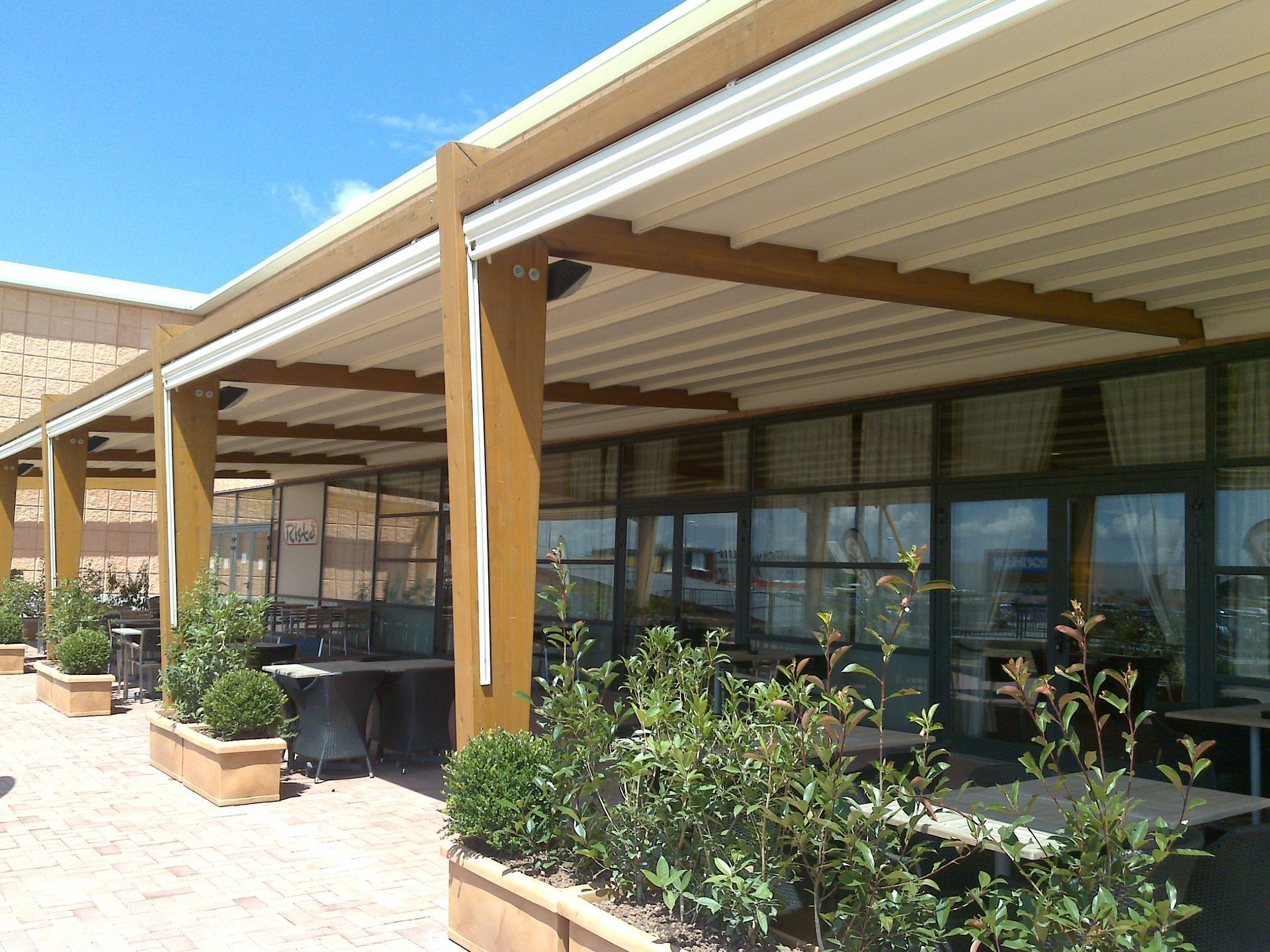 A restaurant with tables and chairs under a canopy - Freehold, NJ - Awning Design Inc