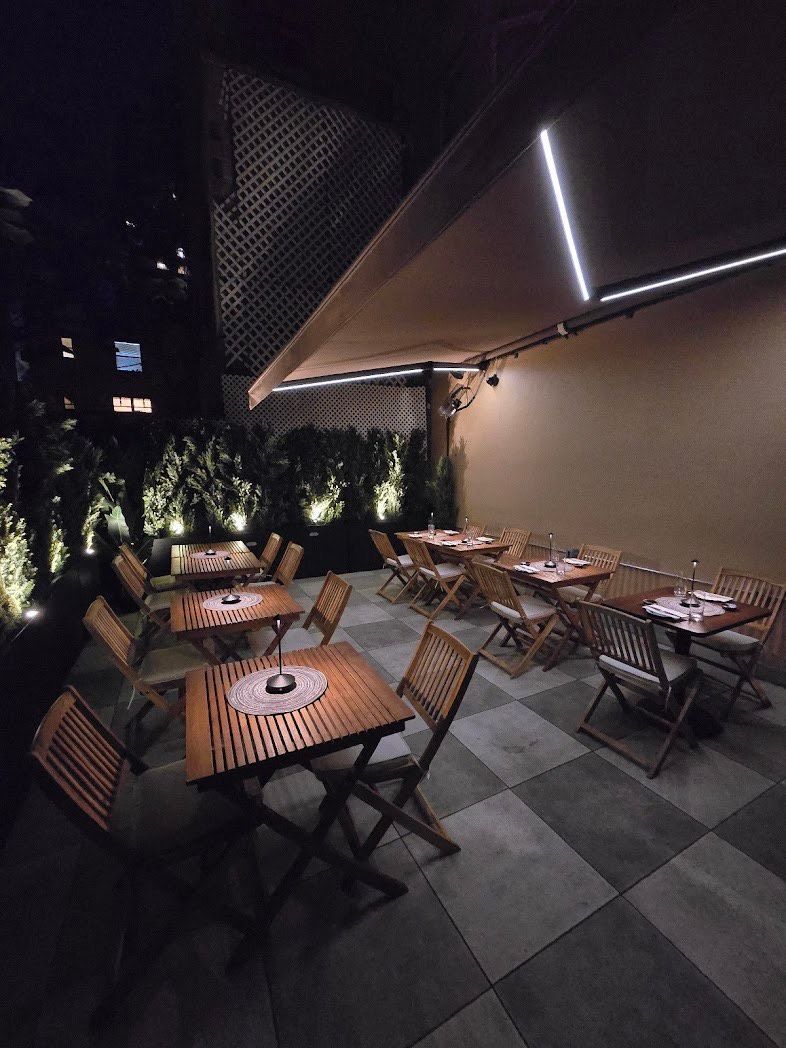 Outdoor dining in nyc with retractable awnings and led lights.