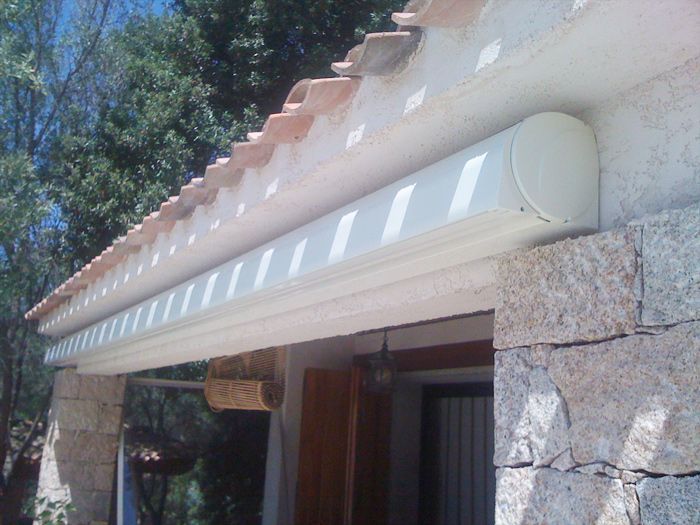 A white awning is hanging from the roof of a building - Freehold, NJ - Awning Design Inc