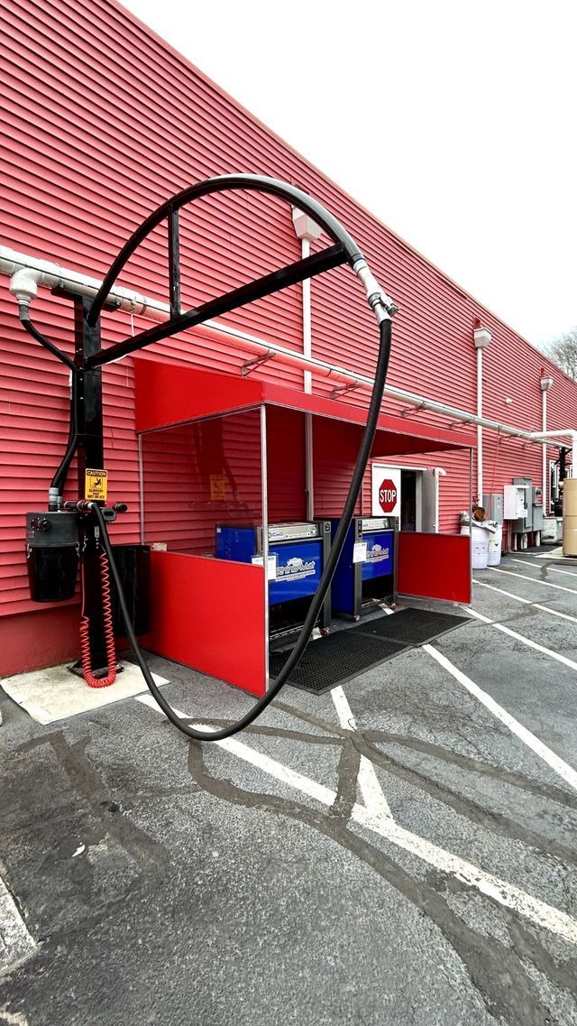 A red building with a large circle in front of it - Freehold, NJ - Awning Design Inc