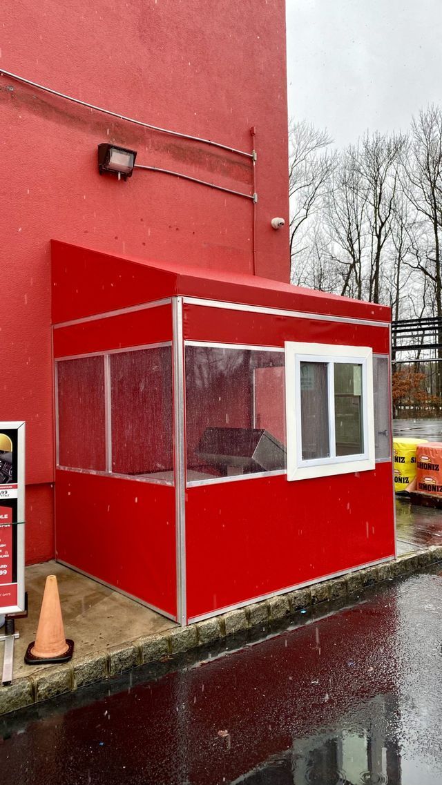 A red building with a white window and a red awning - Freehold, NJ - Awning Design Inc