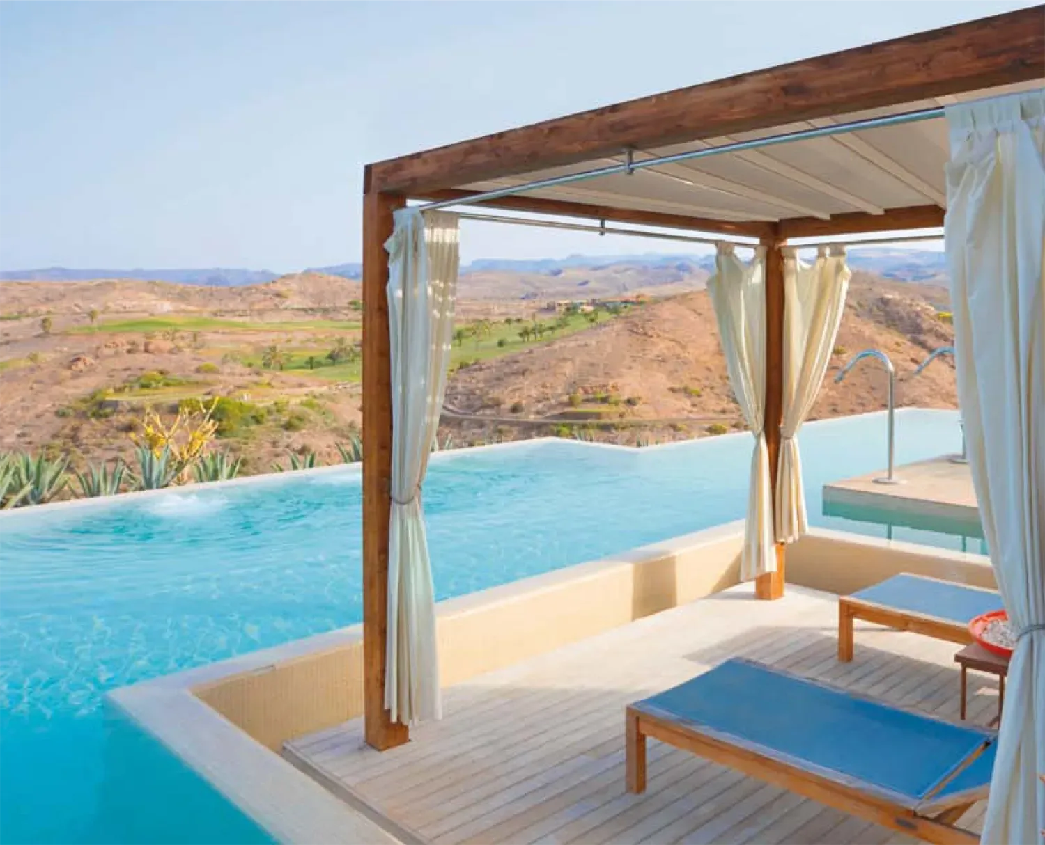 A gazebo overlooking an infinity pool with a view of the mountains - Freehold, NJ - Awning Design Inc