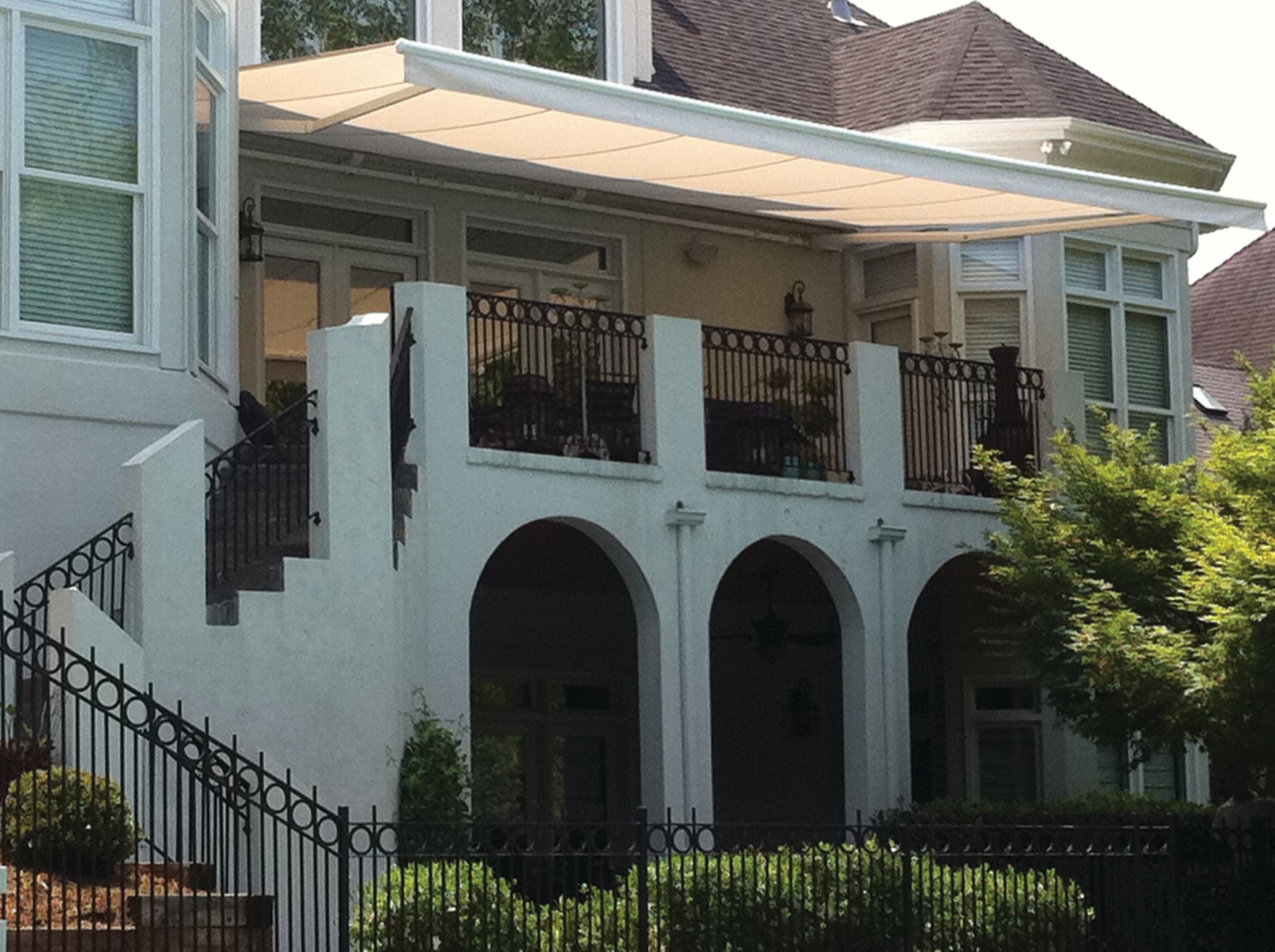 A large white house with a balcony and stairs - Freehold, NJ - Awning Design Inc