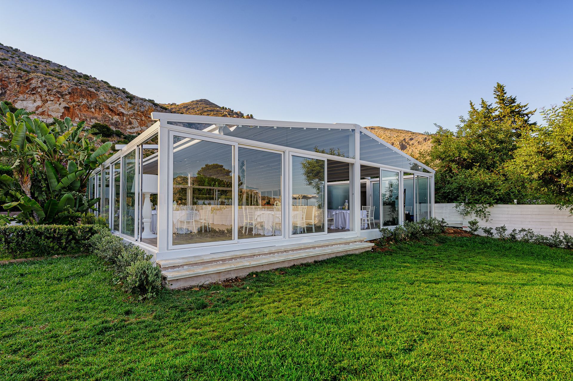A large white tent is sitting in the middle of a lush green field - Freehold, NJ - Awning Design Inc