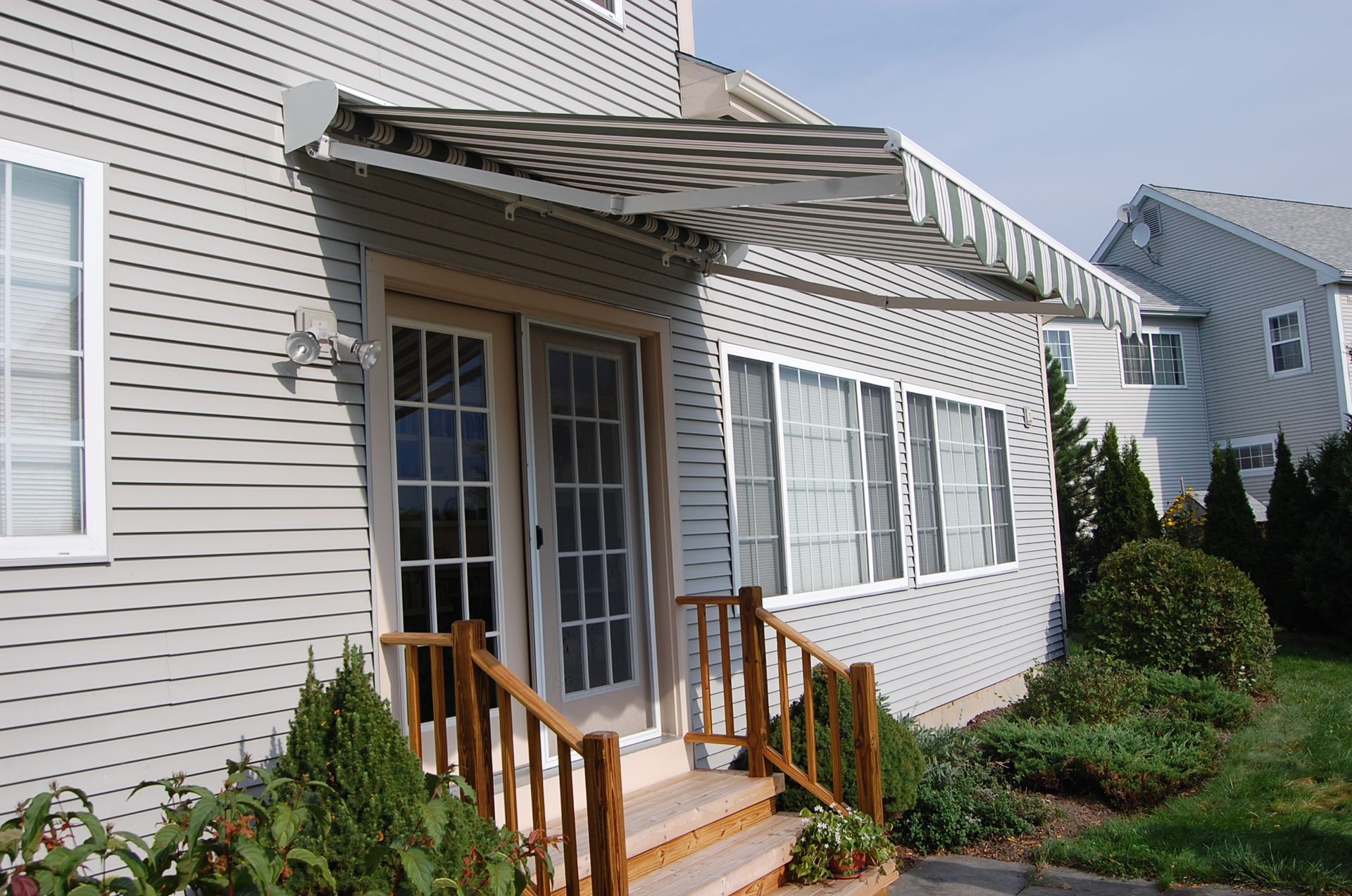 A house with a canopy over the front door - Freehold, NJ - Awning Design Inc