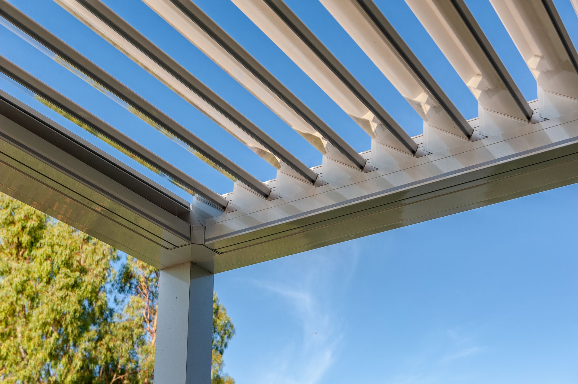 A close up of a pergola with a blue sky in the background - Freehold, NJ - Awning Design Inc
