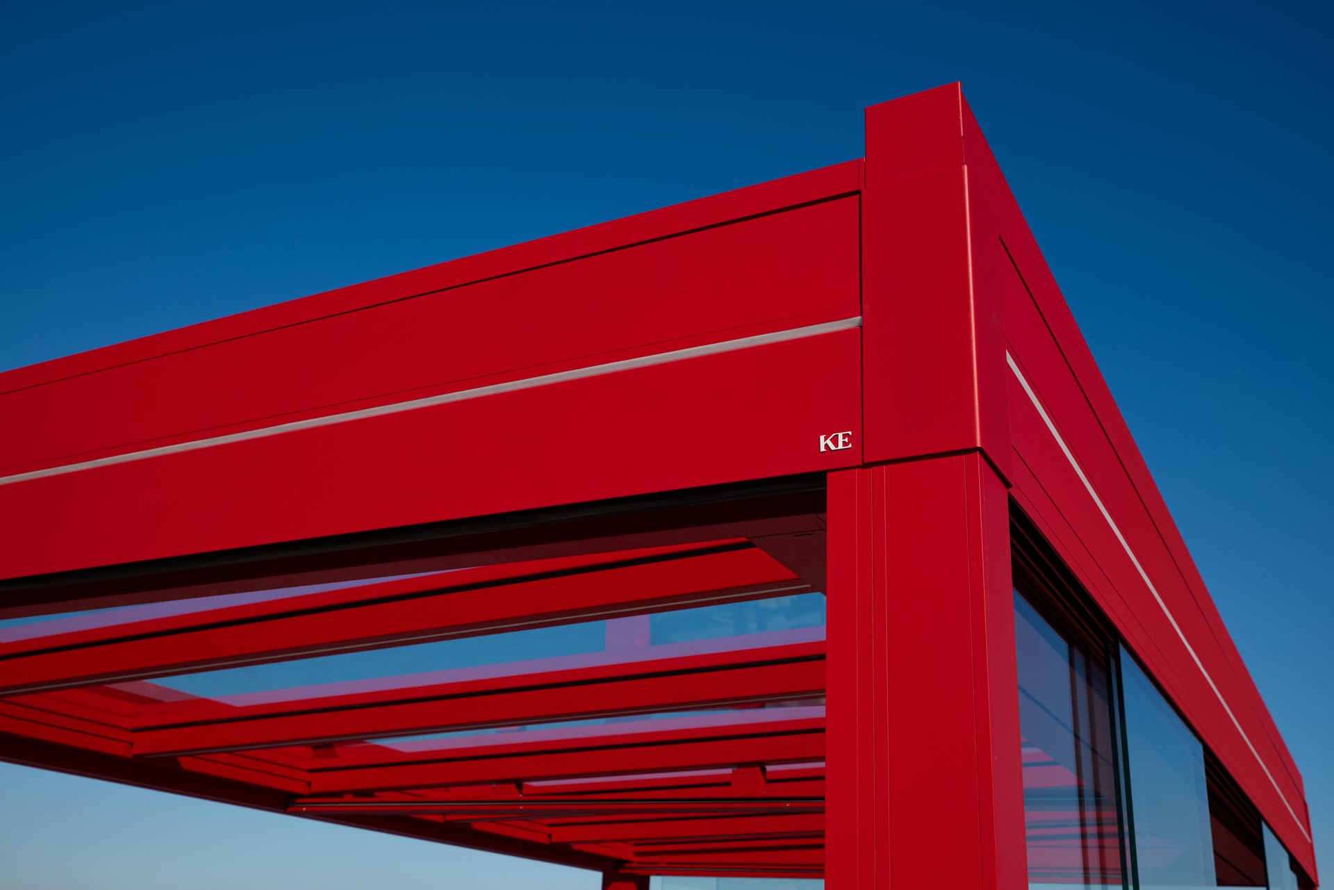 A red building with a blue sky in the background - Freehold, NJ - Awning Design Inc