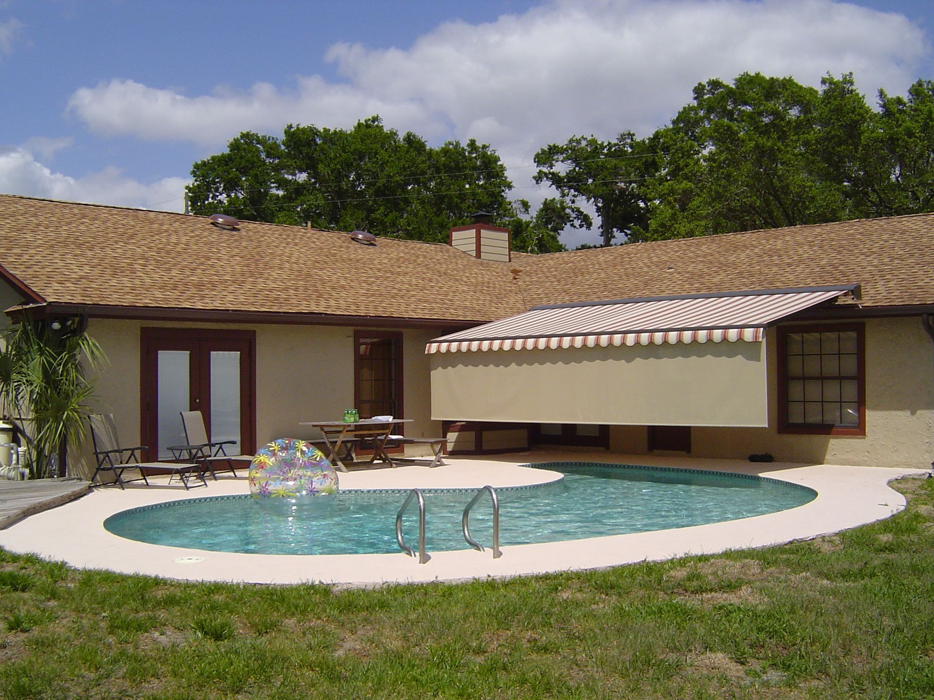 A house with a swimming pool in front of it - Freehold, NJ - Awning Design Inc