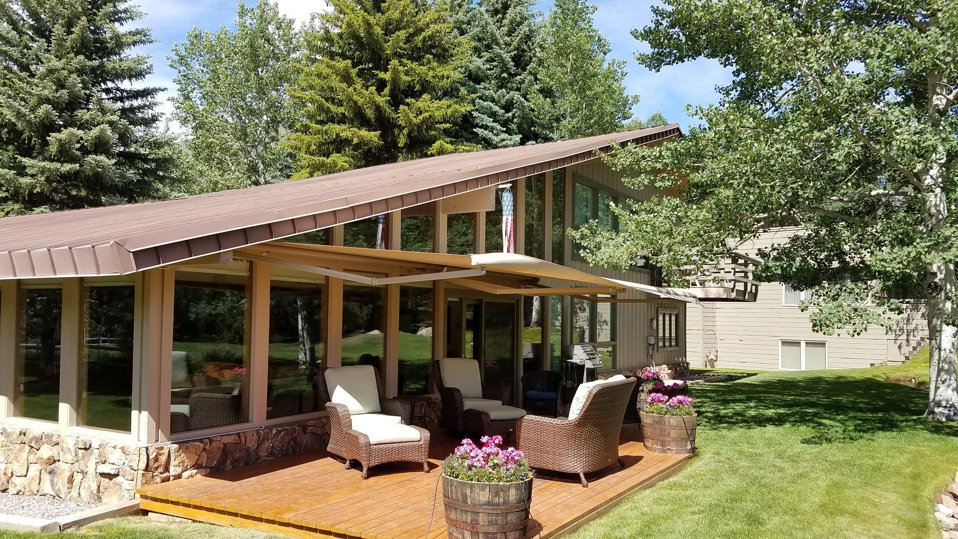 A house with a large patio area in front of it - Freehold, NJ - Awning Design Inc