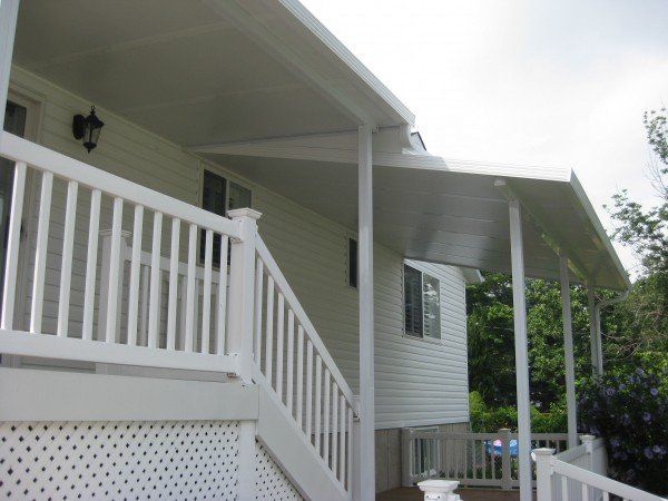 A white house with a covered porch and stairs - Freehold, NJ - Awning Design Inc