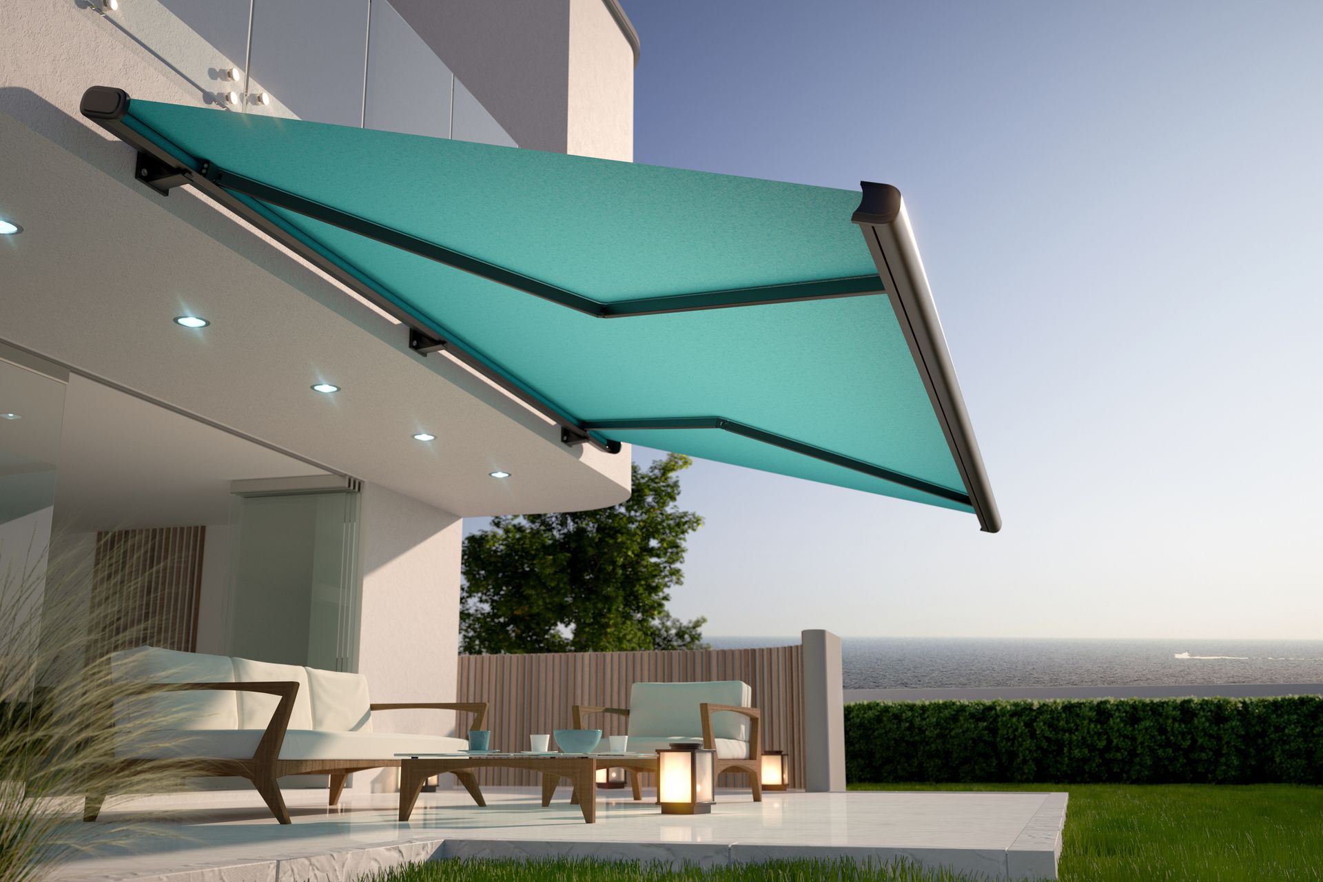 A modern patio with a teal awning, outdoor furniture, lanterns, and a garden view at sunset