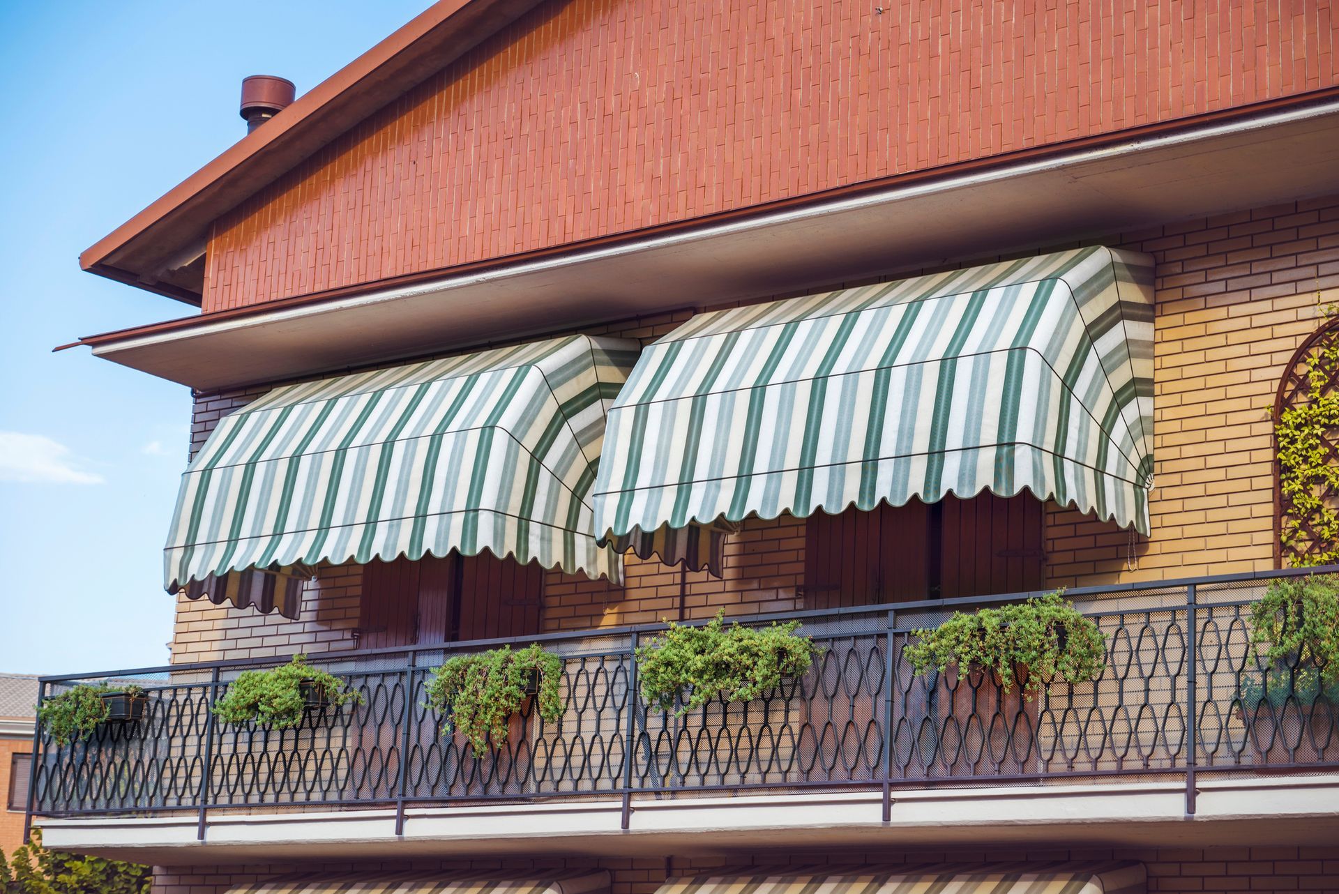 House with Balconies with striped awnings - Residential Awnings, Awning Company