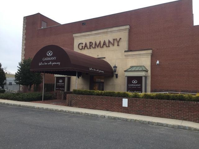 A brick building with the word garmany on it - Freehold, NJ - Awning Design Inc