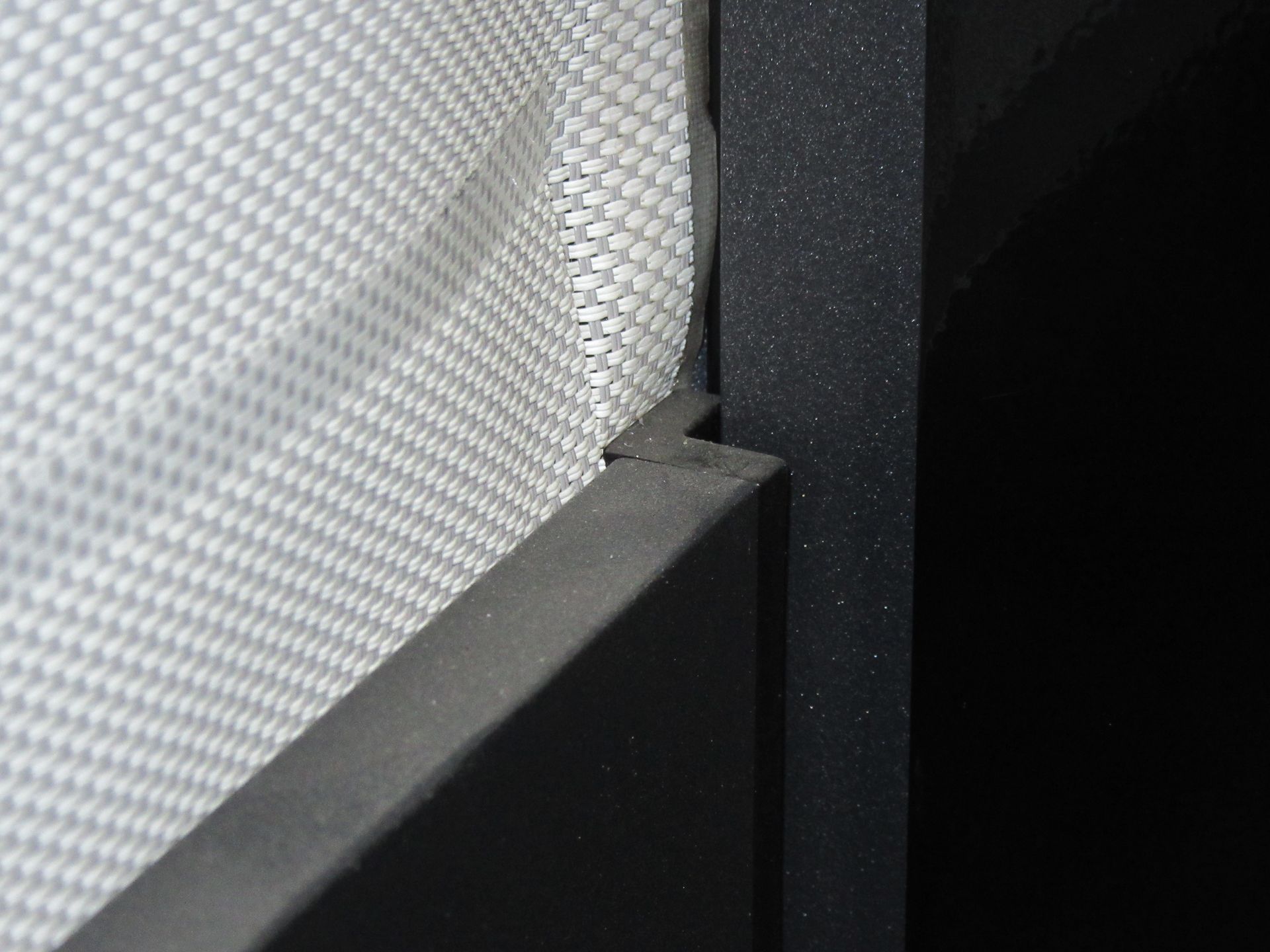 A close up of a piece of fabric on a wall with a black frame - Freehold, NJ - Awning Design Inc