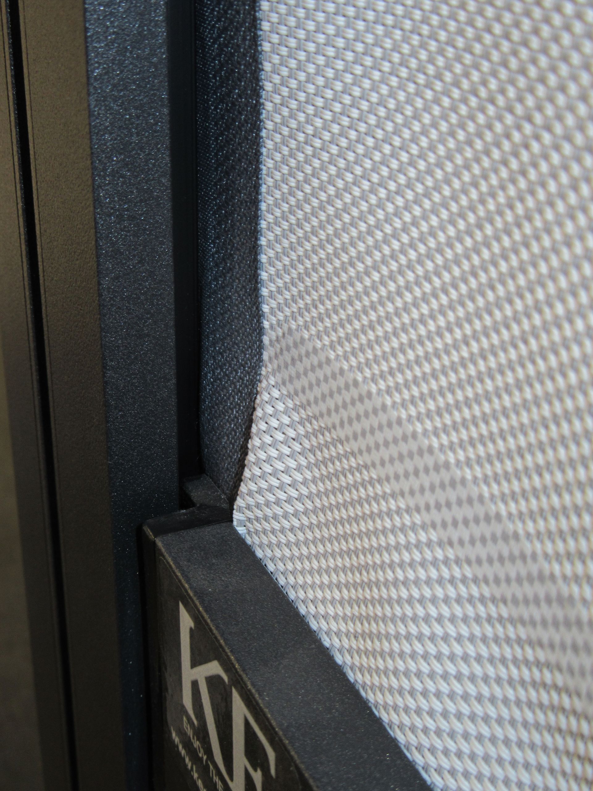 A close up of a screen door with a kf logo on it - Freehold, NJ - Awning Design Inc