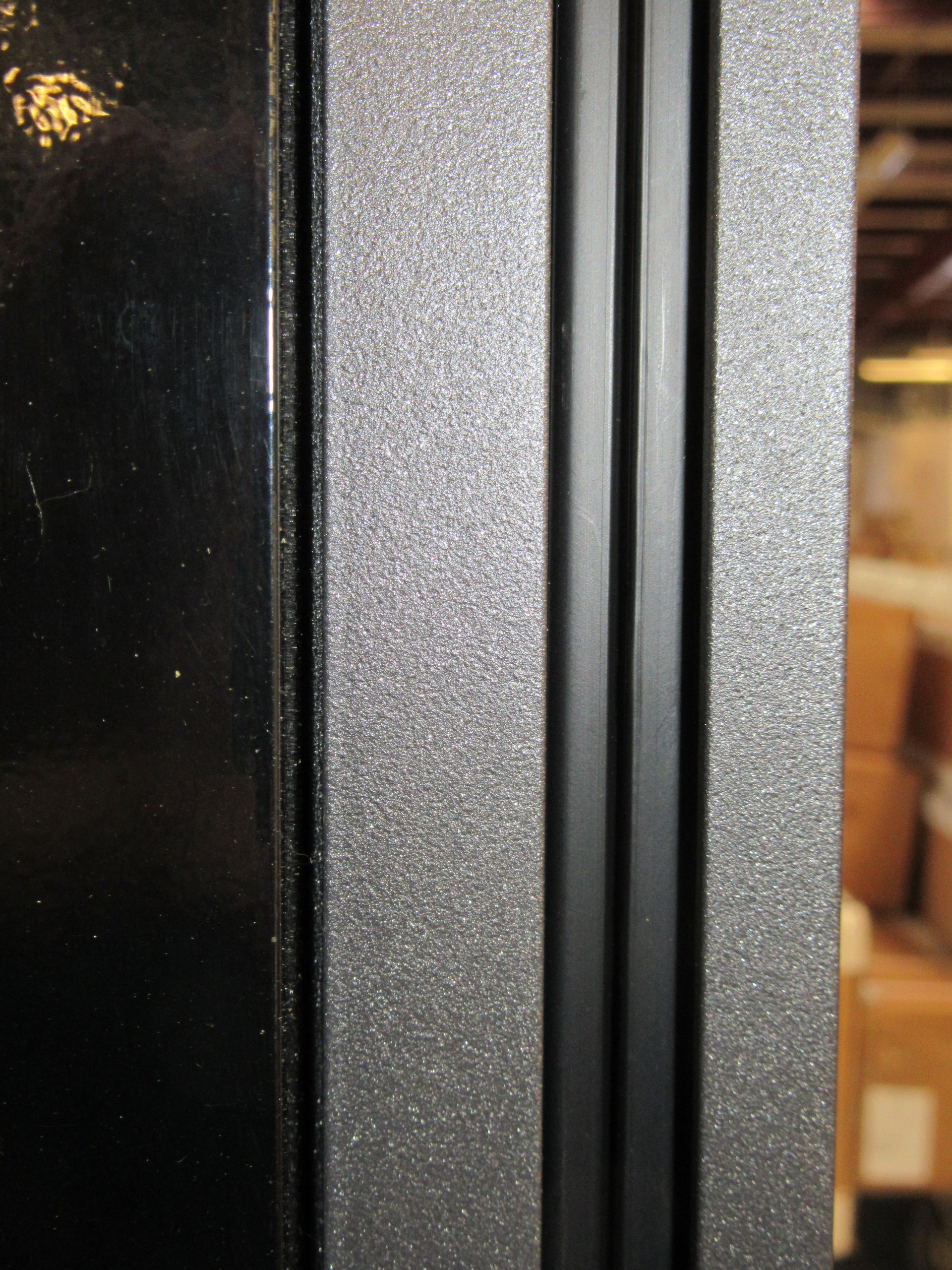 A close up of a black door with a black frame - Freehold, NJ - Awning Design Inc