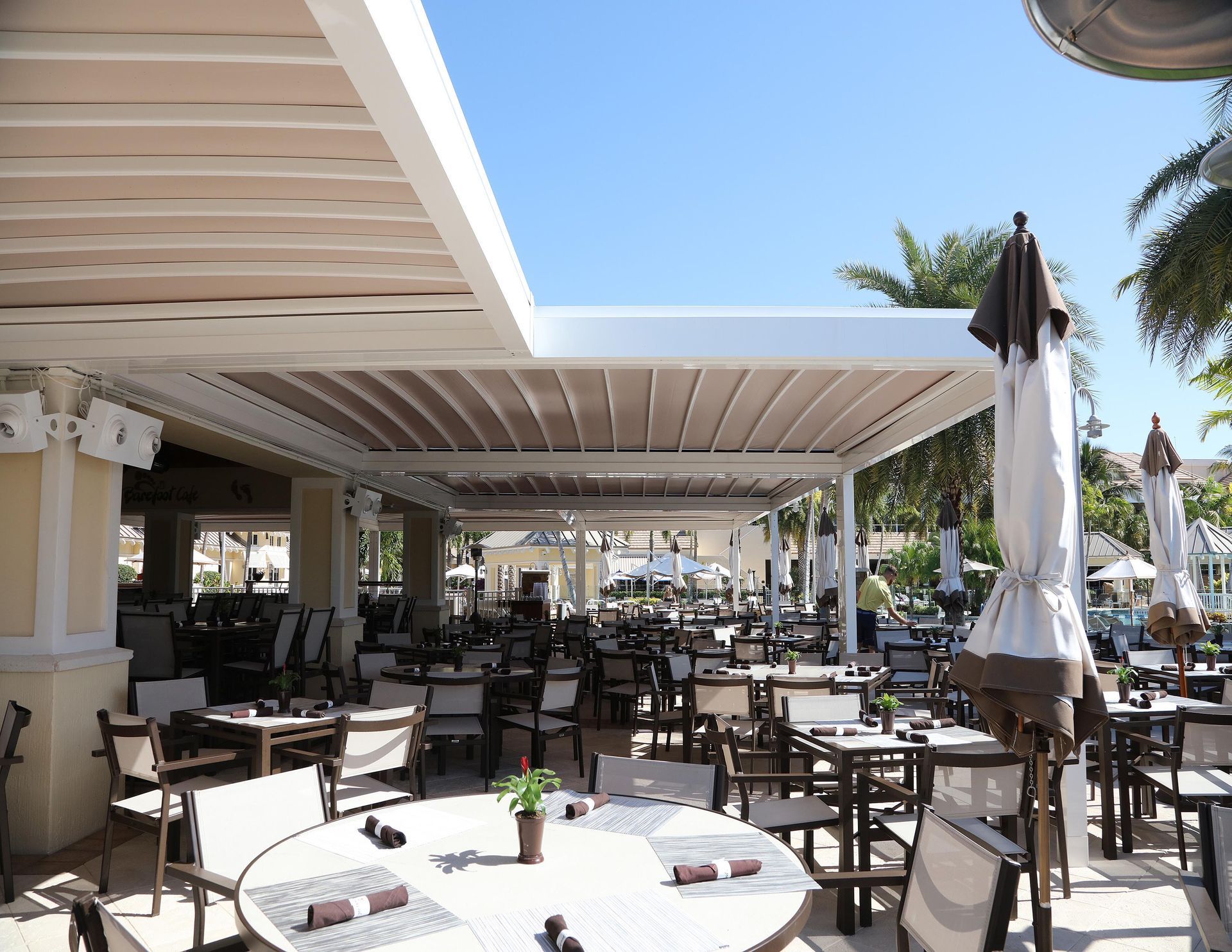 A restaurant with tables and chairs under a canopy - Freehold, NJ - Awning Design Inc