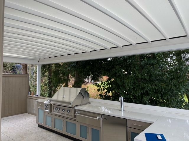 A kitchen with a grill and a sink under a canopy - Freehold, NJ - Awning Design Inc