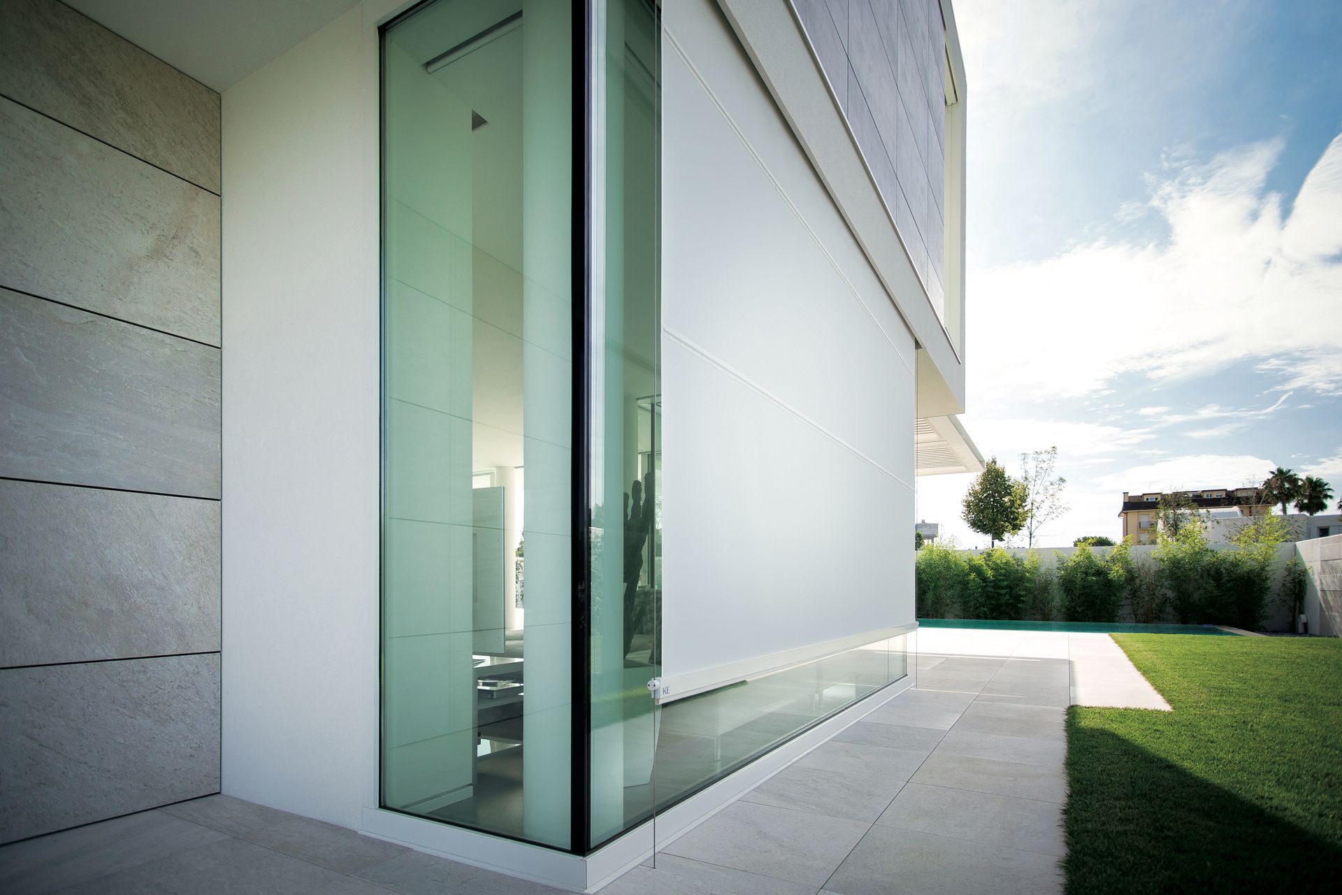 A white building with a large glass door - Freehold, NJ - Awning Design Inc