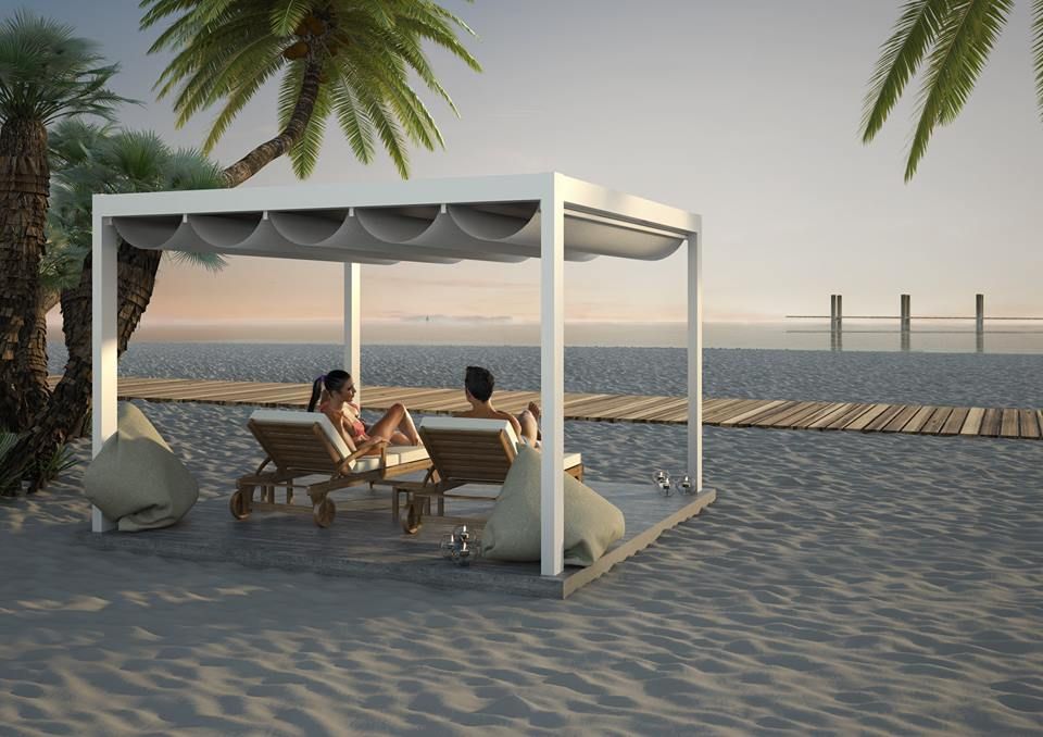 A couple is sitting under a canopy on the beach - Freehold, NJ - Awning Design Inc