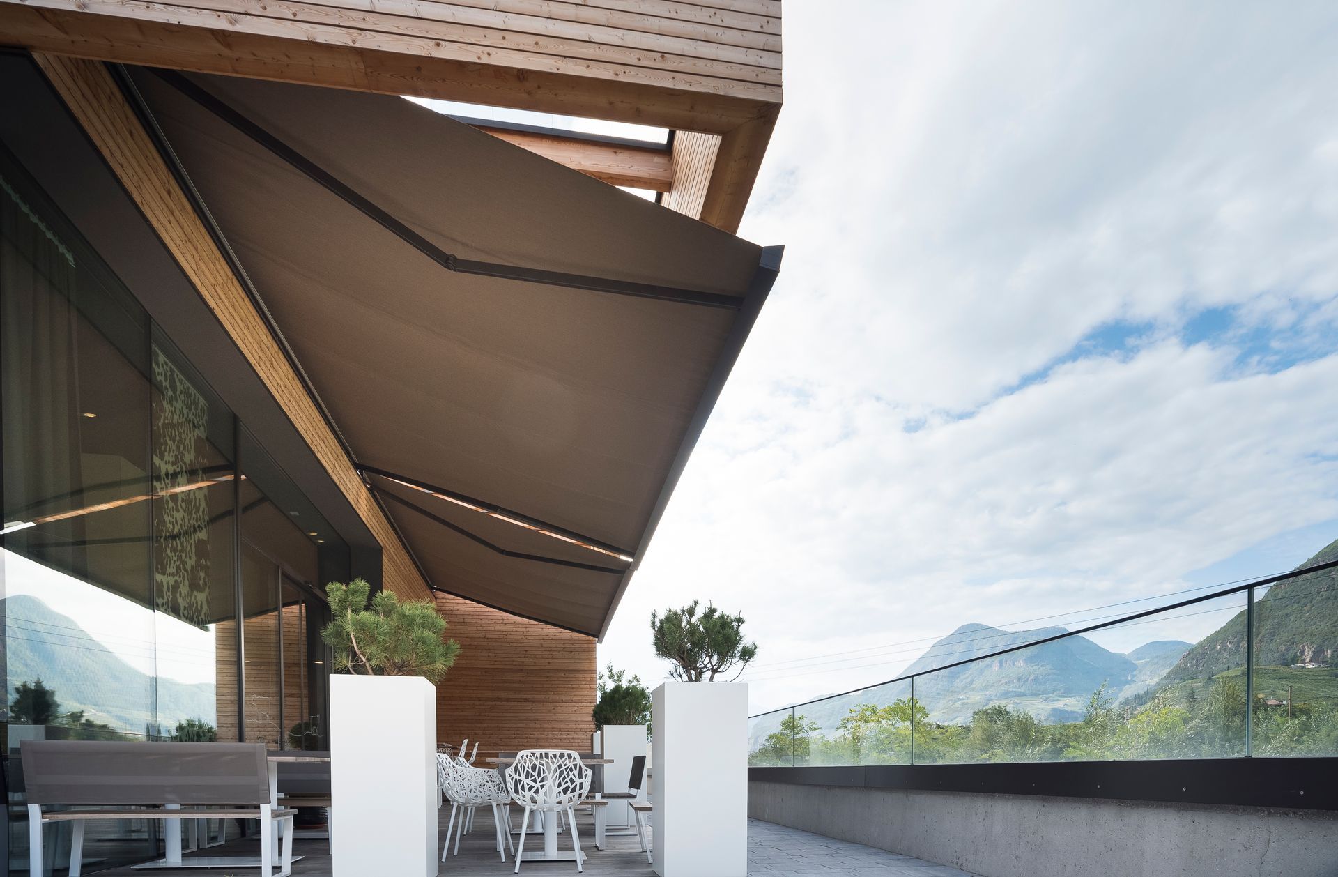 A balcony with a large awning over it and mountains in the background - Freehold, NJ - Awning Design Inc