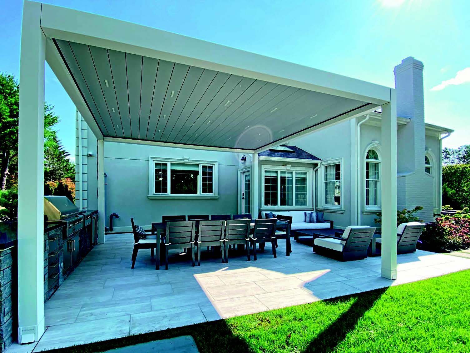 A patio with a table and chairs under a pergola - Freehold, NJ - Awning Design Inc