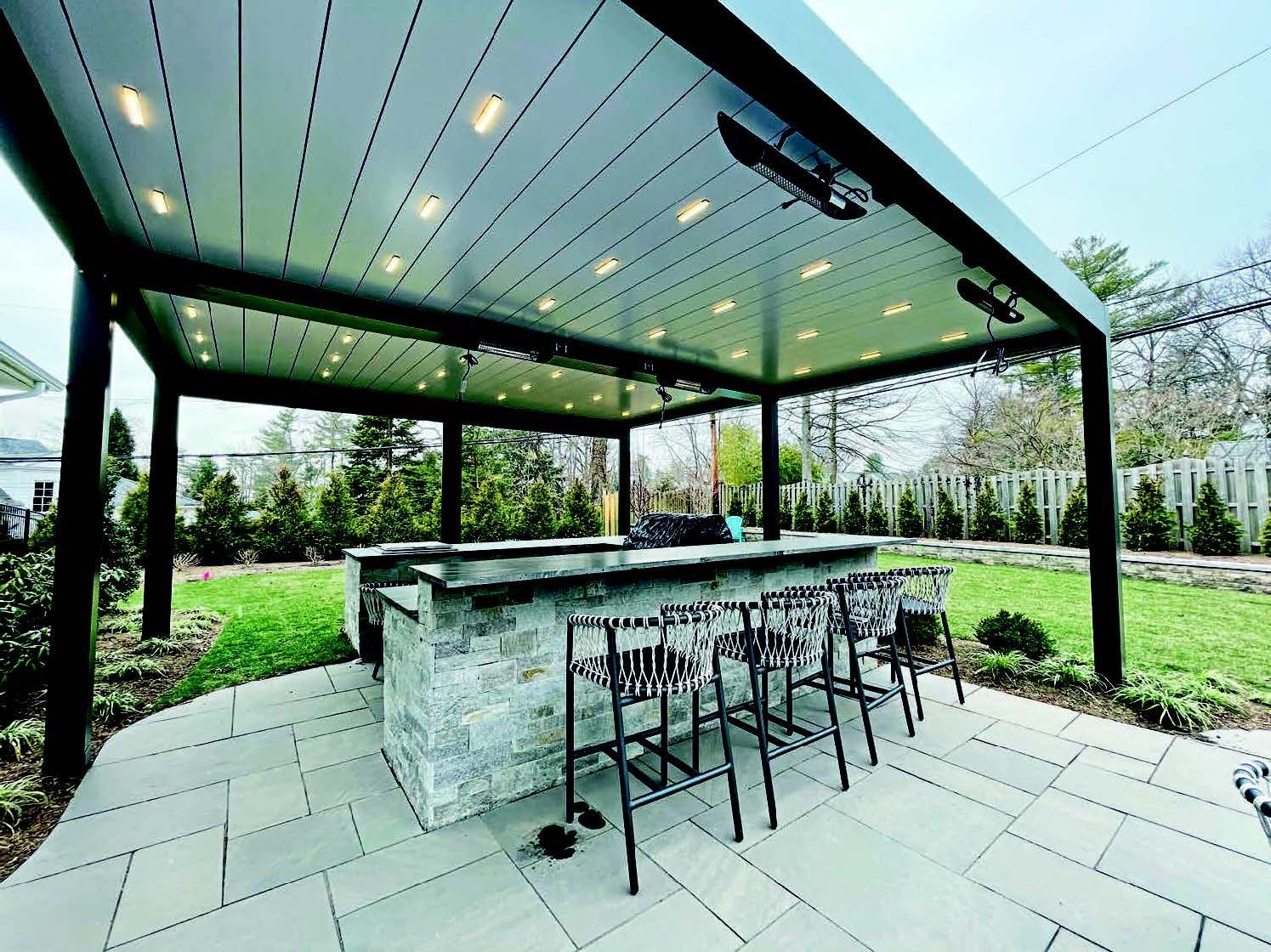 A patio with a bar and chairs under a canopy - Freehold, NJ - Awning Design Inc