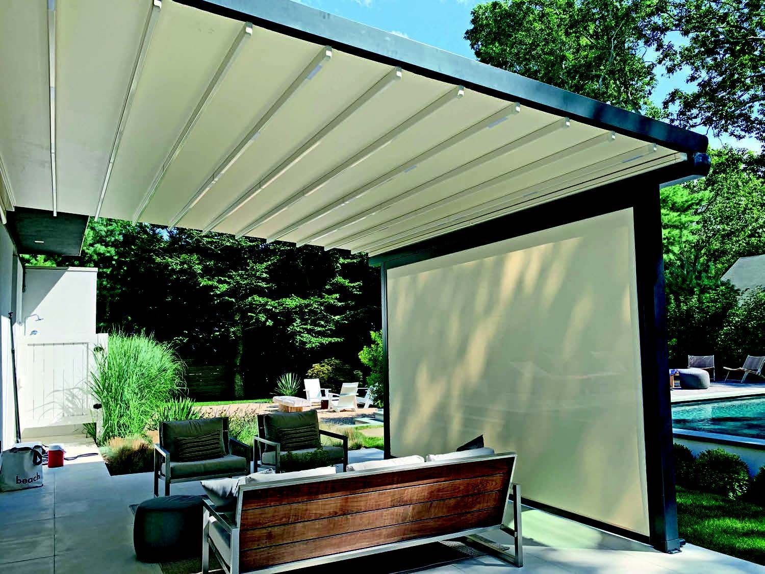 A patio with a couch and chairs under a canopy - Freehold, NJ - Awning Design Inc