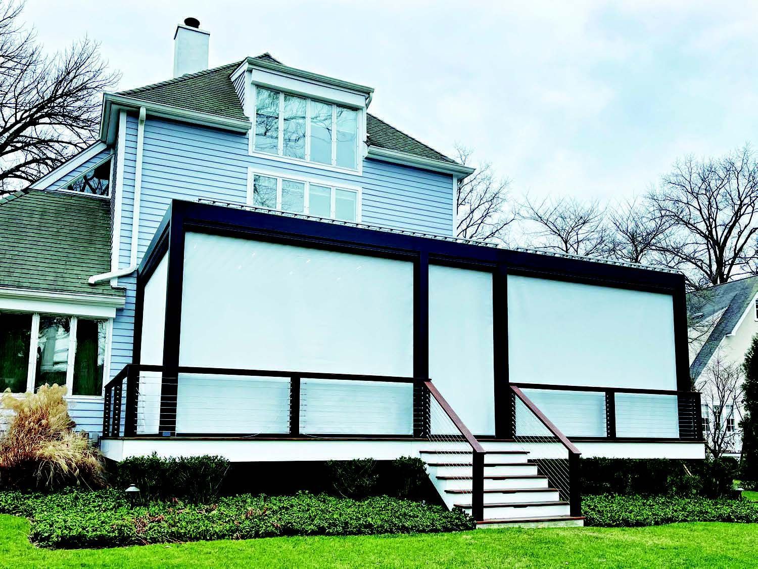 A house with a screened in porch and stairs - Freehold, NJ - Awning Design Inc