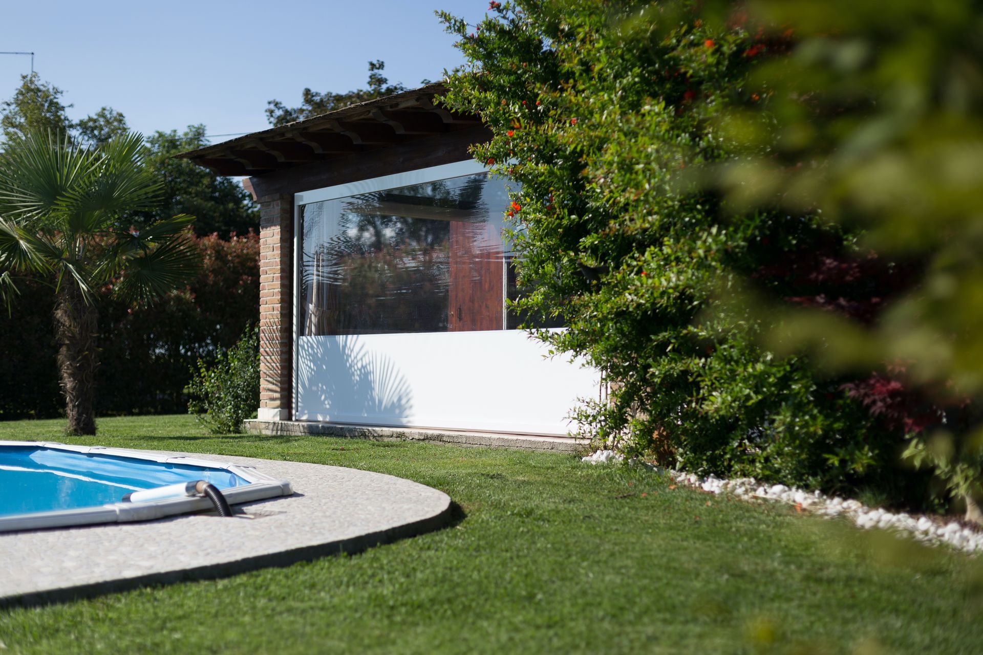 There is a swimming pool in the backyard of a house - Freehold, NJ - Awning Design Inc