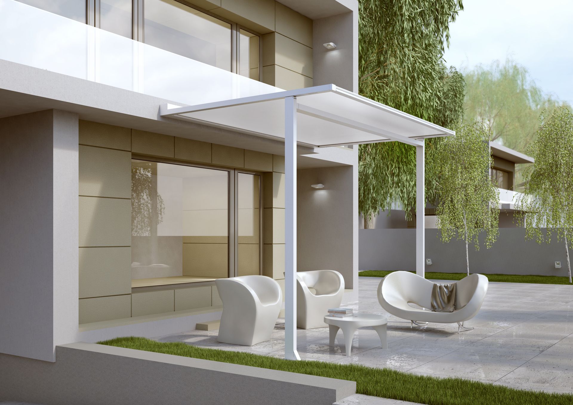 A white house with a patio area with chairs and a table - Freehold, NJ - Awning Design Inc