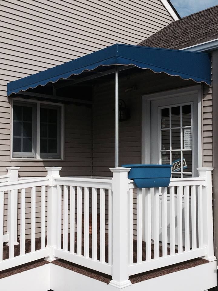 A white porch with a blue awning over it - Freehold, NJ - Awning Design Inc