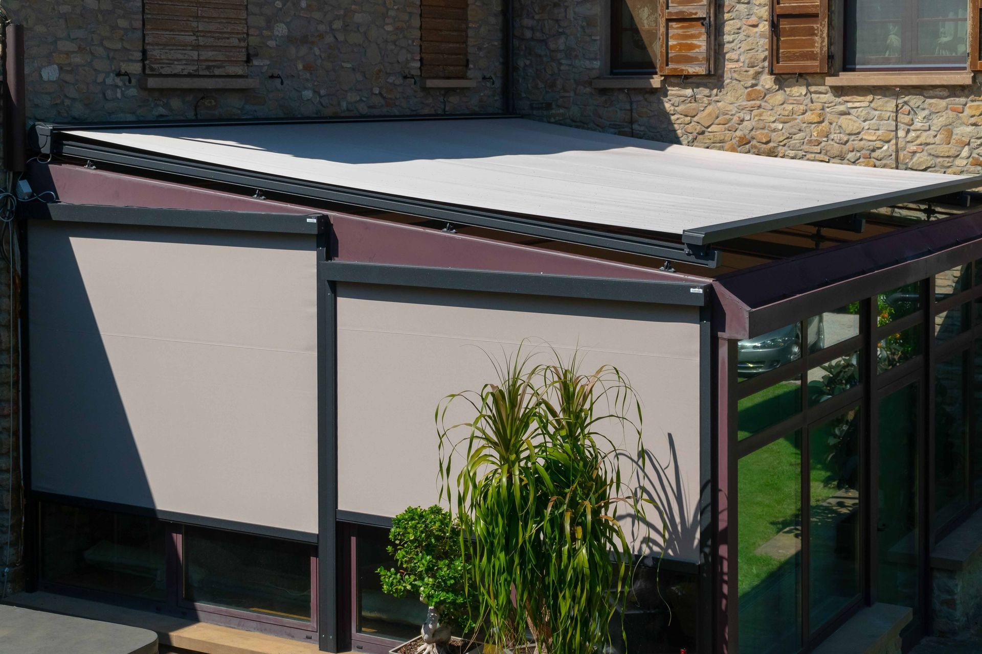 A house with a roof that has a shade on it - Freehold, NJ - Awning Design Inc