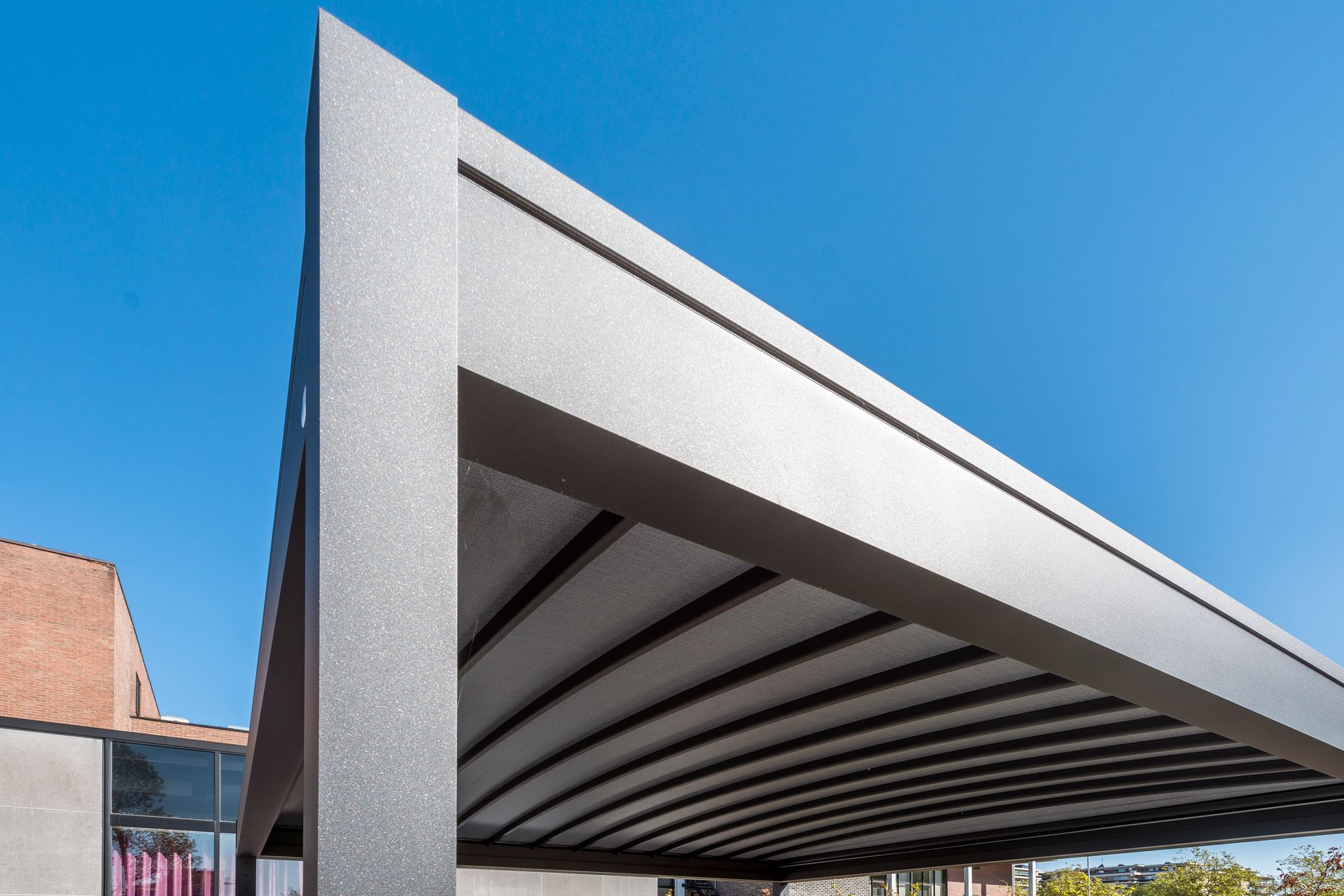 A carport with a blue sky in the background - Freehold, NJ - Awning Design Inc