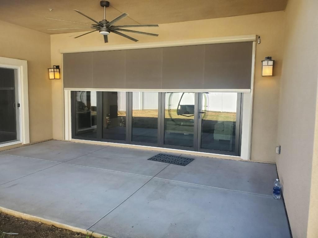 A patio with sliding glass doors and a ceiling fan - Freehold, NJ - Awning Design Inc