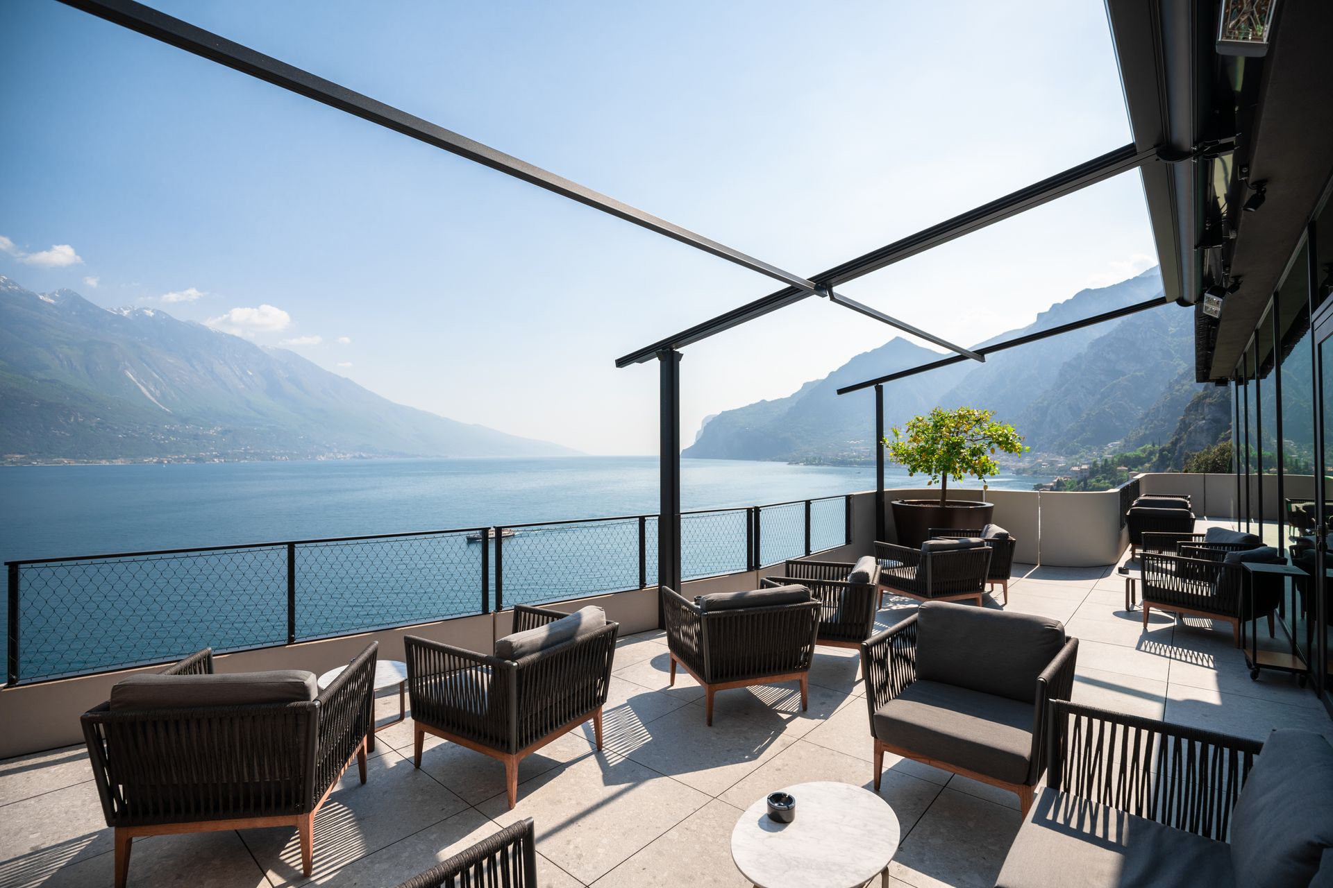 A patio with a view of a lake and mountains - Freehold, NJ - Awning Design Inc